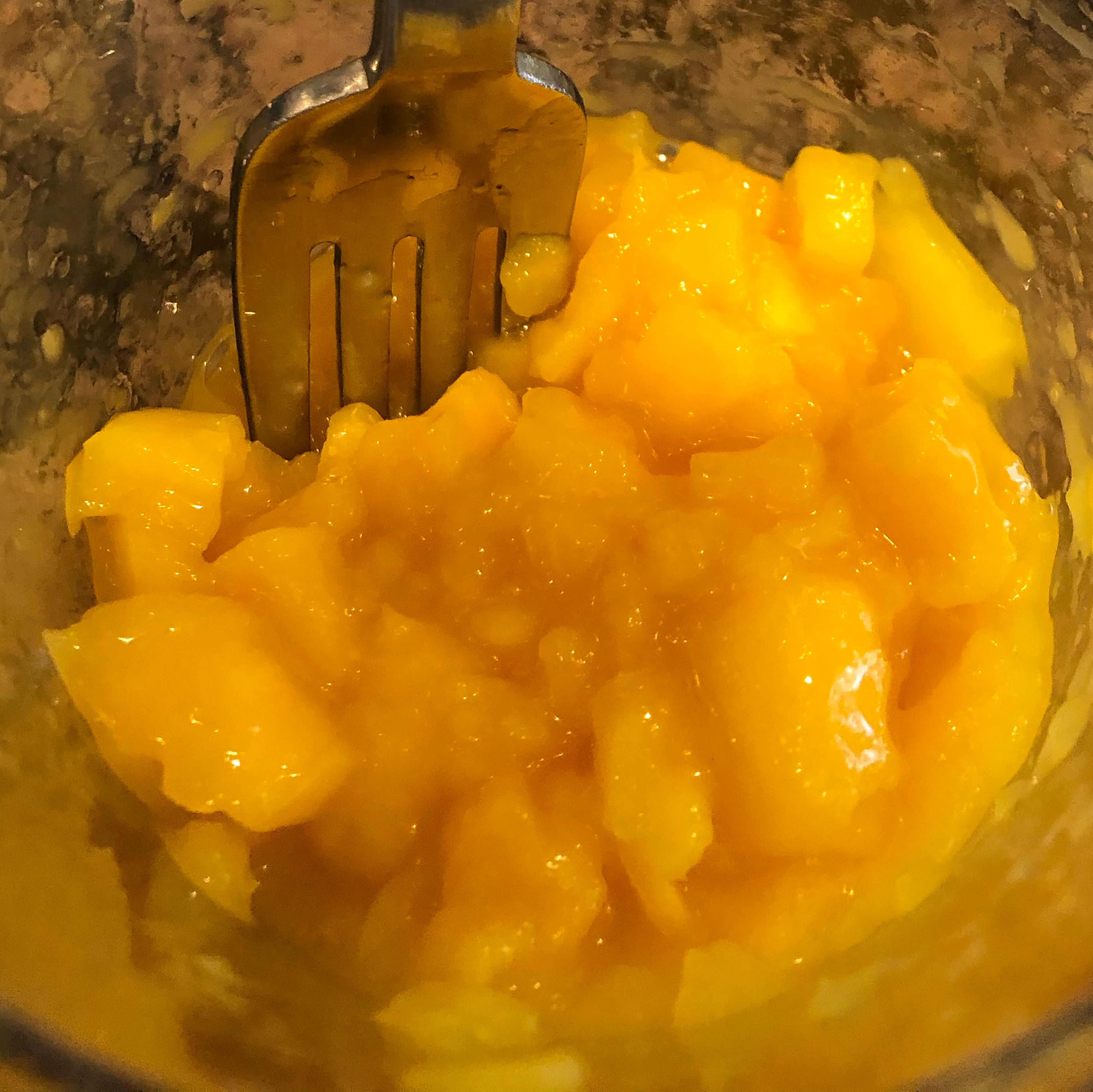 Use an immersion blender to partially blend the mango. The mango should have some chunks still in it, but should also have some fully blended pieces.