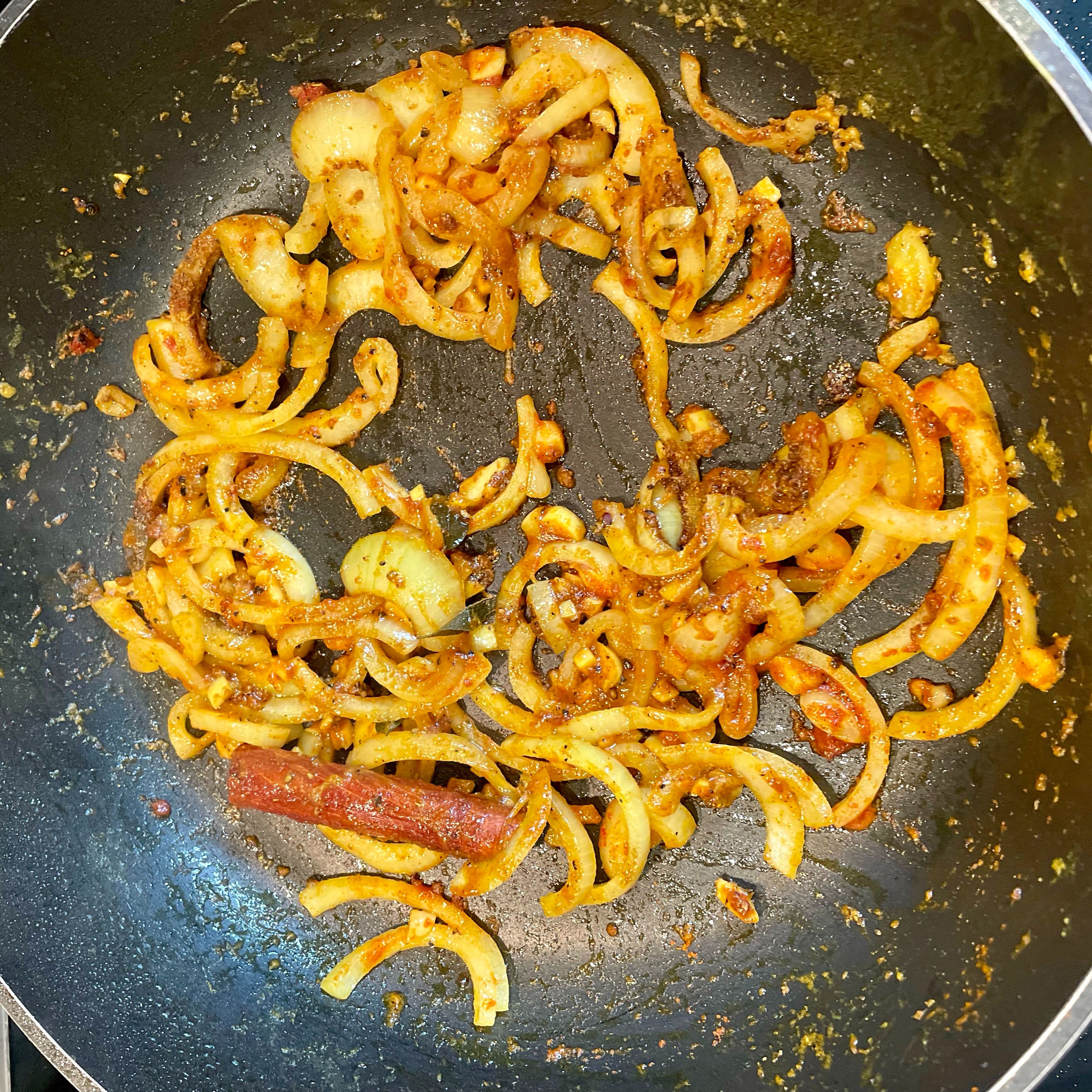 Fry onions, garlic, ginger, cinnamon and curry leaves till onions start to brown. Add salt, unroasted curry powder and cayenne pepper.