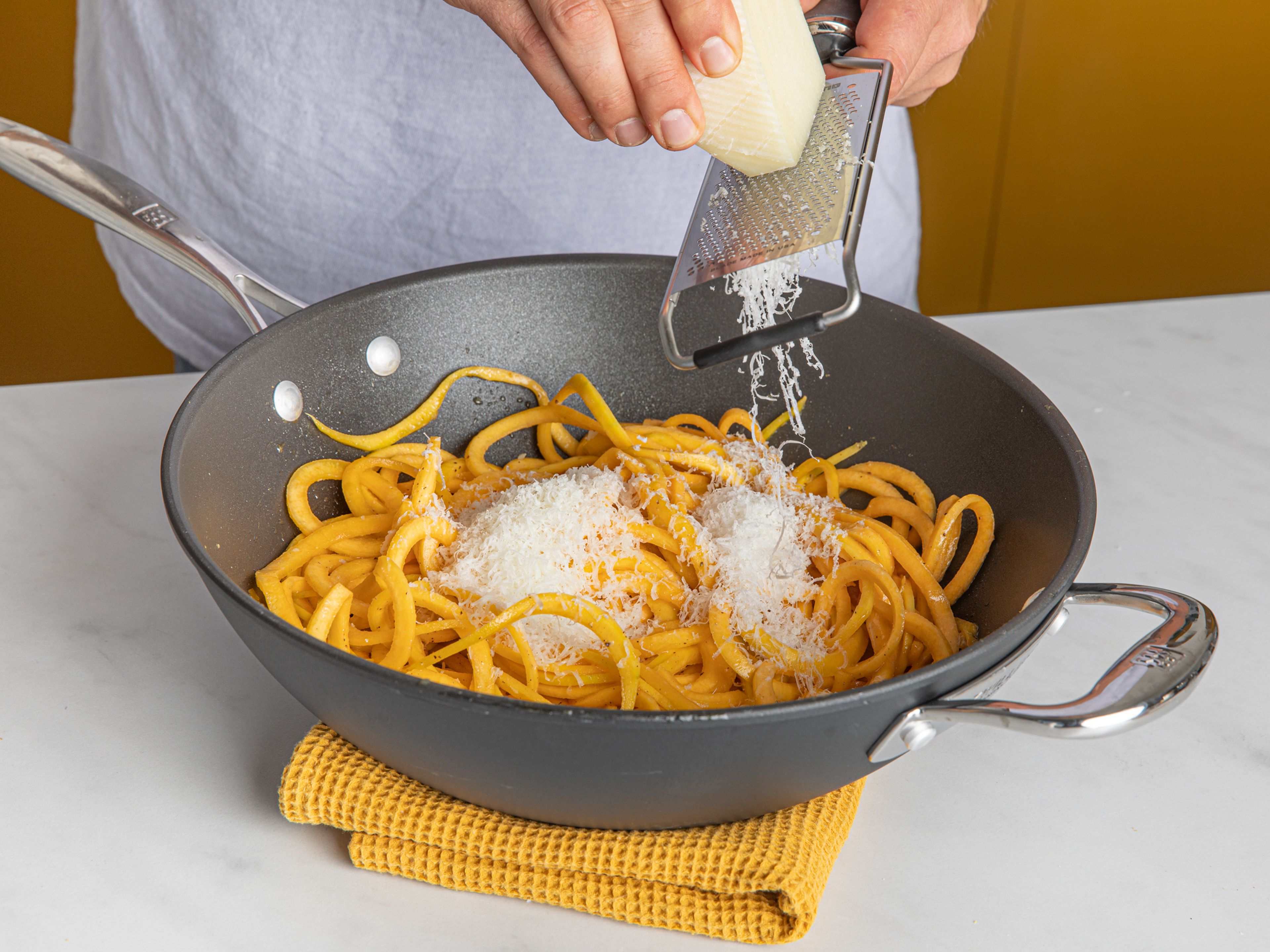 In a large frying pan over medium heat, melt butter. Add freshly ground black pepper and stir, letting toast for approx. 30 sec. Add some water, then add the squash noodles and miso. Toss to combine, then remove from heat when ready and add grated pecorino and remaining butter. Toss well until noodles are coated in the sauce, then season to taste with salt and serve immediately. Enjoy!
