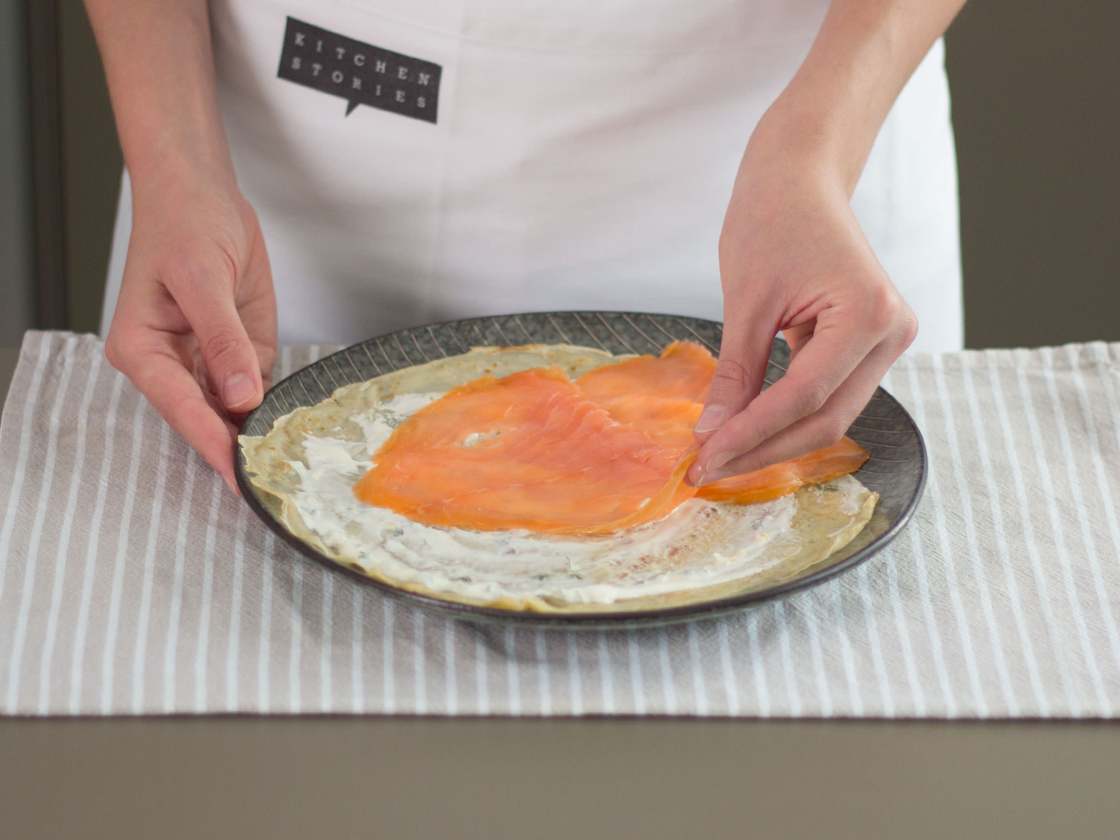 When the crepes have cooled down, spread an even, thin layer of crème fraiche on top, fill with smoked salmon, and roll up for serving. Garnish with a dollop of crème fraiche and salmon caviar.