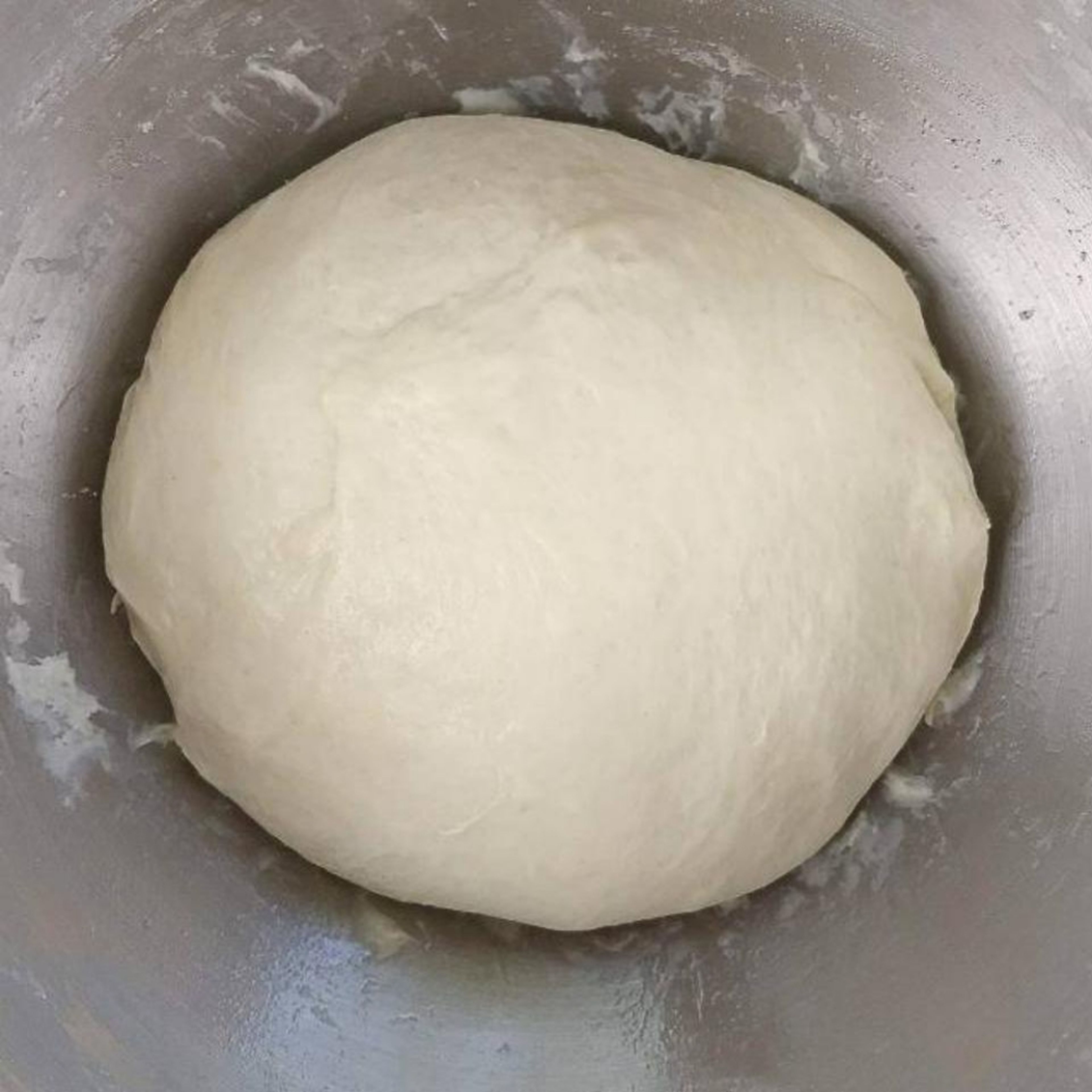 Put flour, warm water, 1 tbsp of olive oil, 1tsp of salt, 1 tsp of sugar and yeast in a bowl. Knead the dough with hands or automatically with yeast dough hooks for 10min. At the end it should look like a ball diverging from the sides of the bowl. It dpesnt matter if its a little sticky.