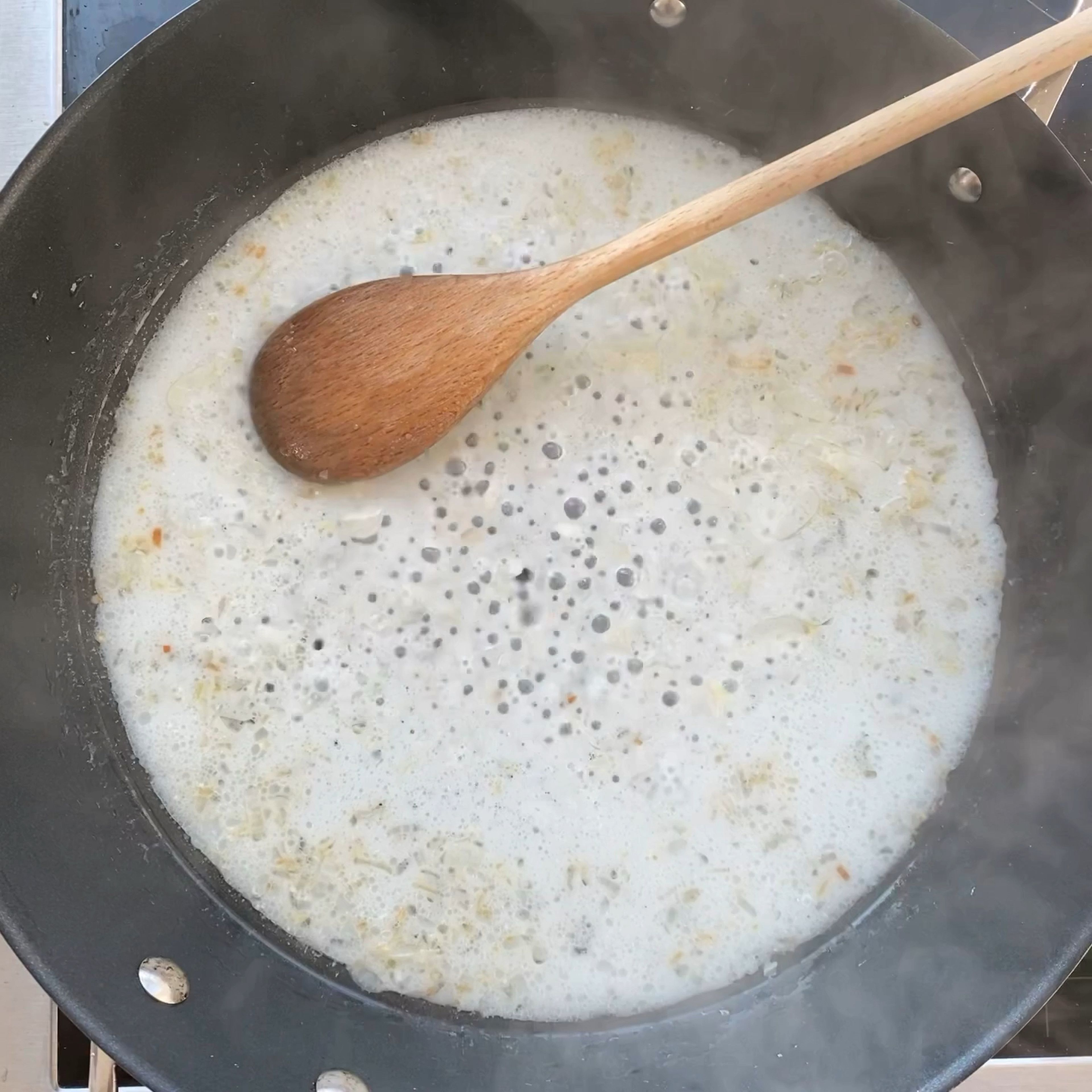 Halve the cherry tomatoes and set aside. Deglaze the lemon mixture with the coconut milk and put on high heat to reduce the fluid stirring every now and then. Reduce the heat after about 5 minutes and let simmer for another 10 minutes. In the mean time bring a big pot of salted water to boil.