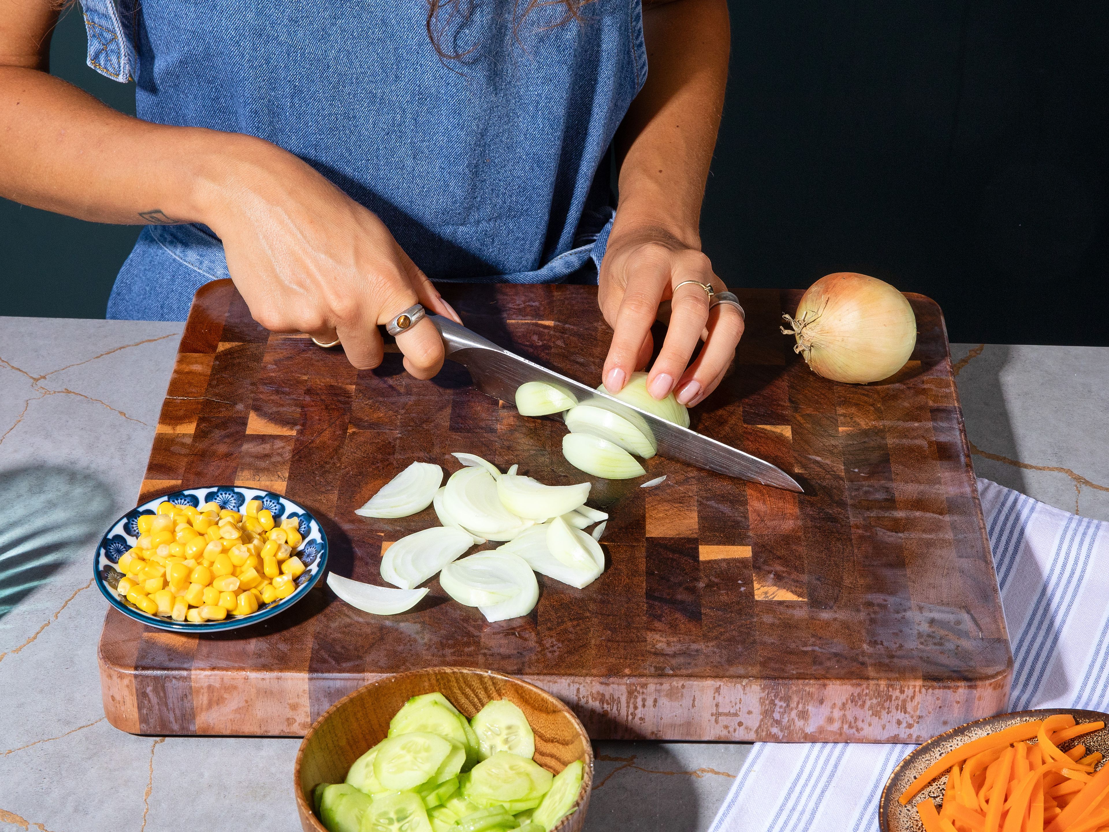Meanwhile, bring a small pot of water to a boil. Cut carrots into thin sticks and blanch for approx. 5 min. Remove with a slotted spoon and set aside. Carefully add eggs to the same water and hard-boil for approx. 10–12 min. Drain corn in a sieve. Meanwhile, cut cucumber into thin slices and onion into thin wedges. Toss cucumber slices with some salt and let sit for approx. 10 min. Then squeeze out any excess liquid thoroughly.