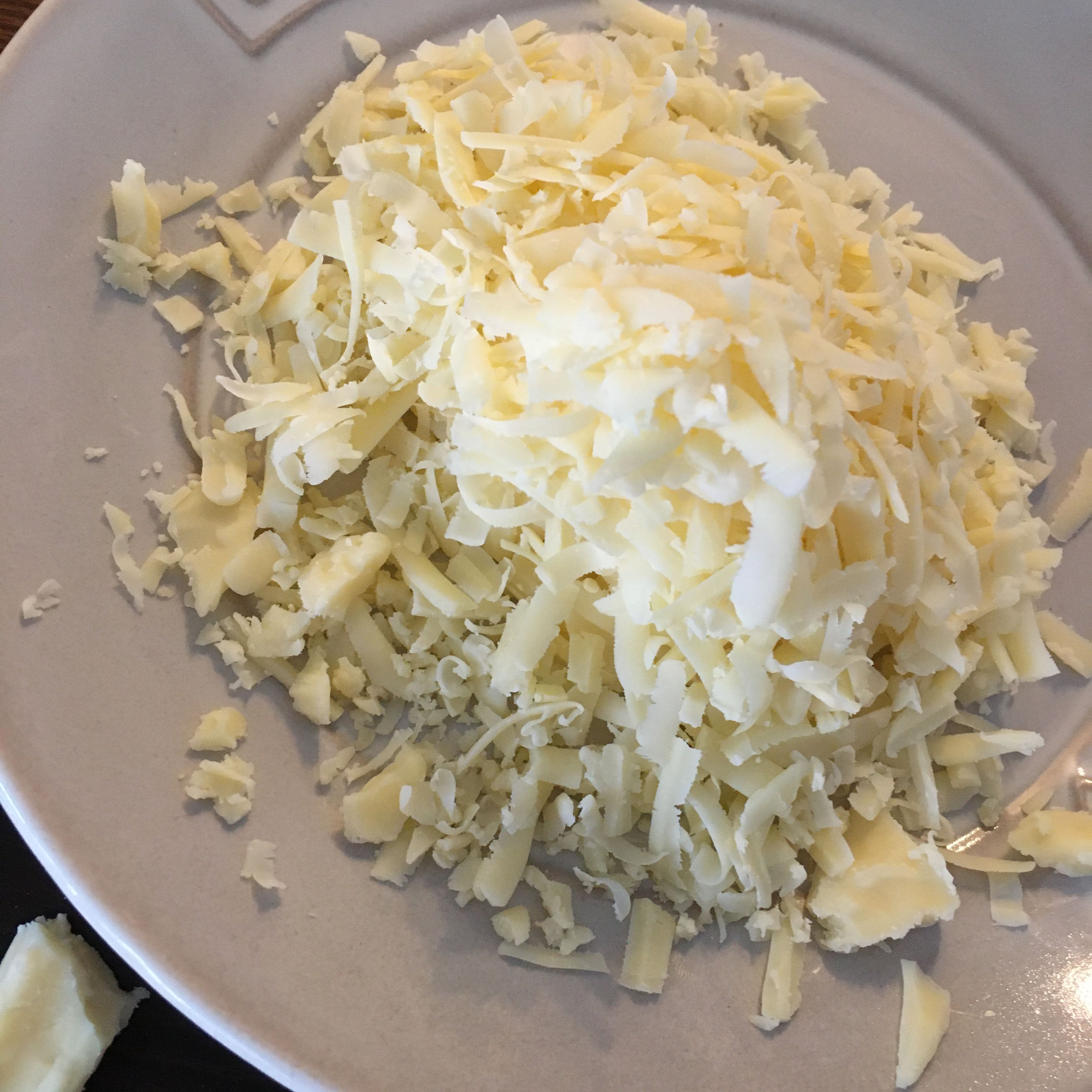 Add 2/3 of the cheddar and add all of the Parmesan.