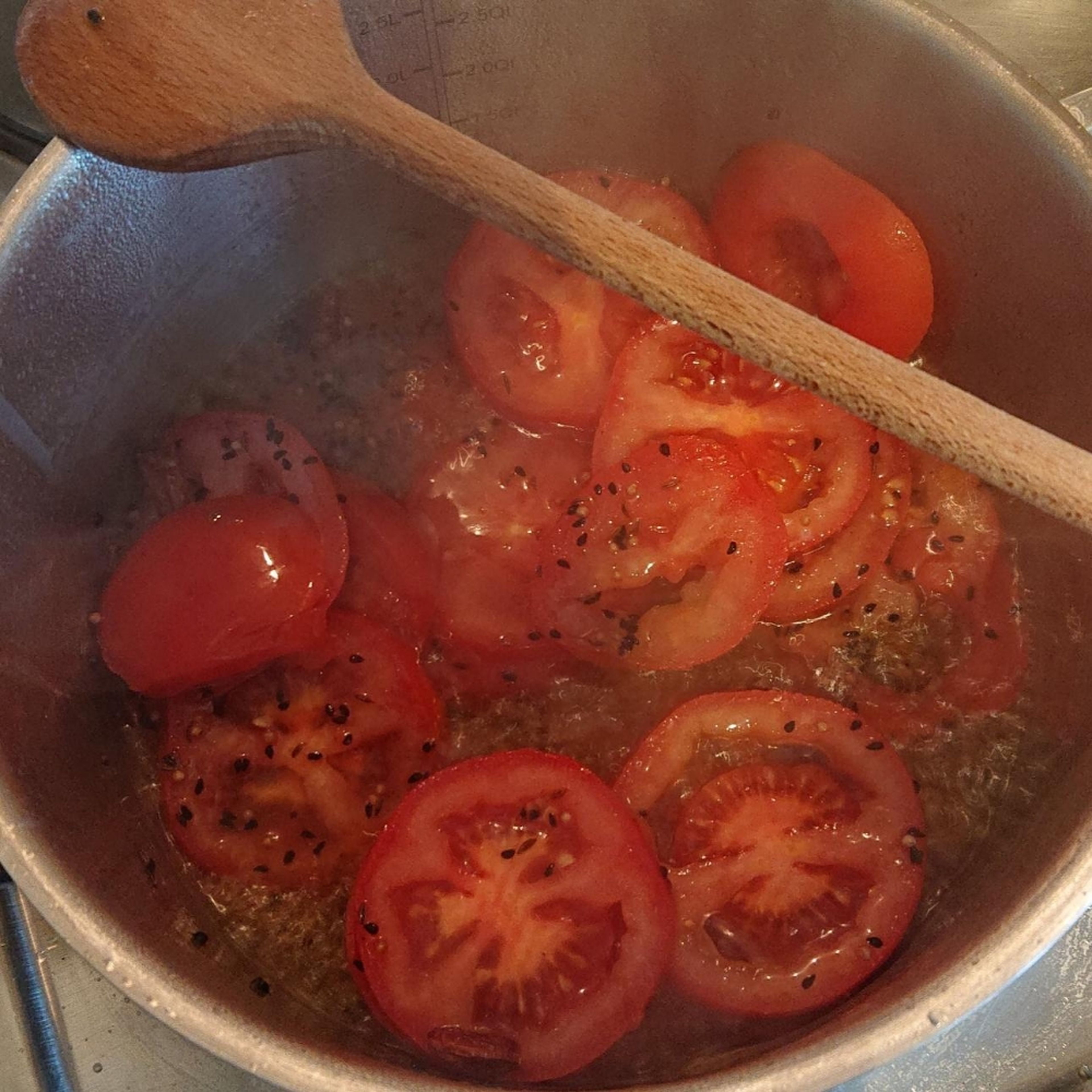 Die Tomaten in Scheiben schneiden und in die Gewürzmischung geben. Alles 3 - 5 Minuten anbraten.