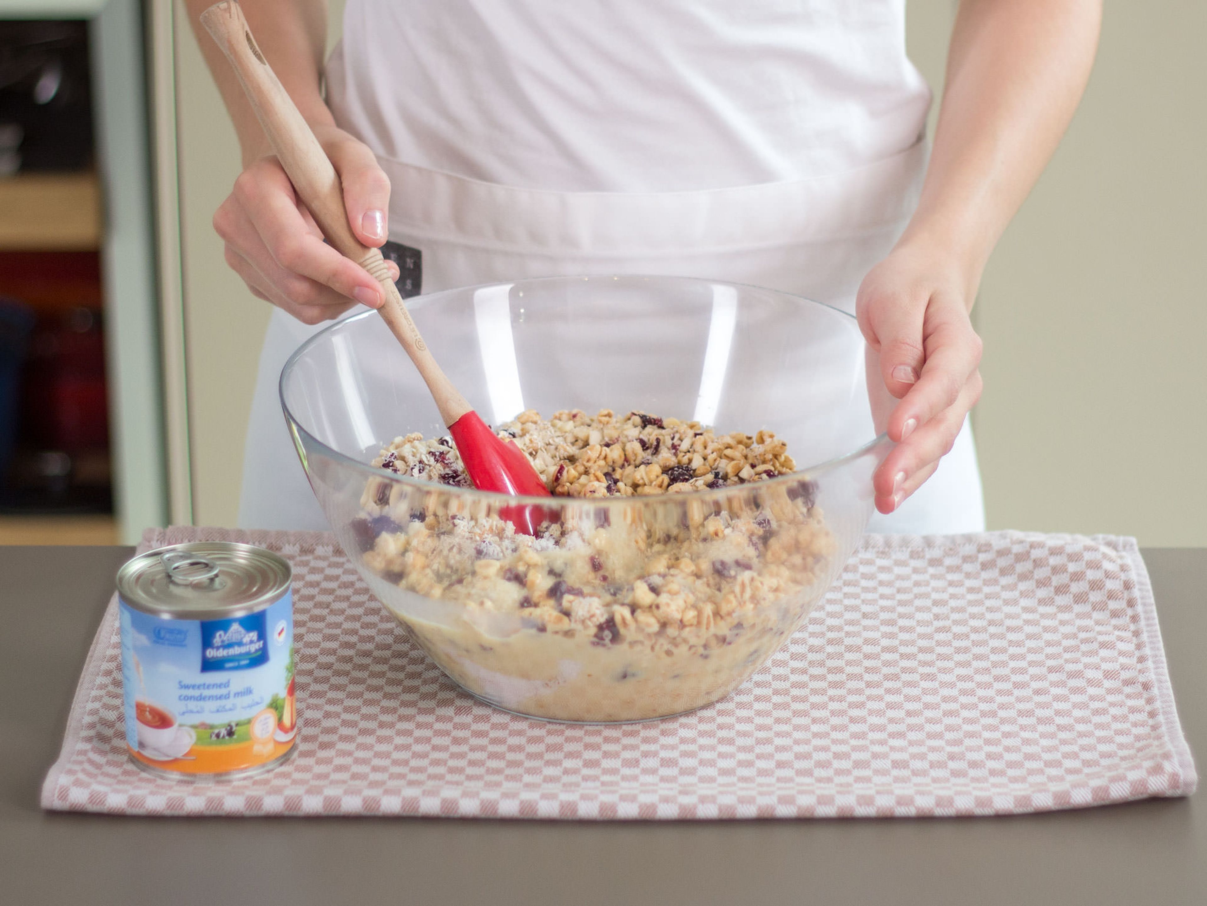 Add warm sweetened condensed milk to bowl and stir thoroughly until ingredients are well combined.