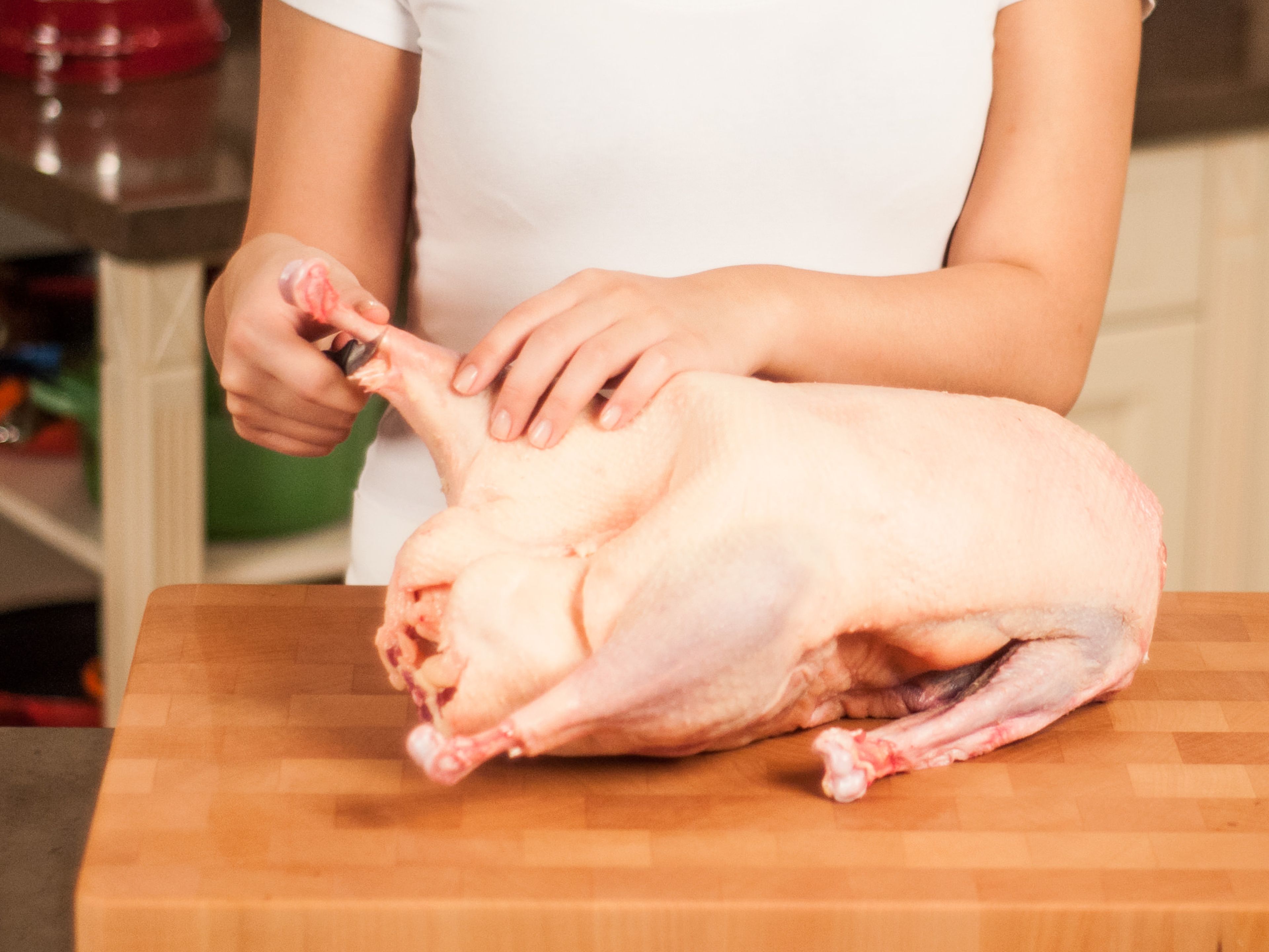 With a sharp knife, trim skin around goose ankles to loosen skin and allow fat to render while cooking.