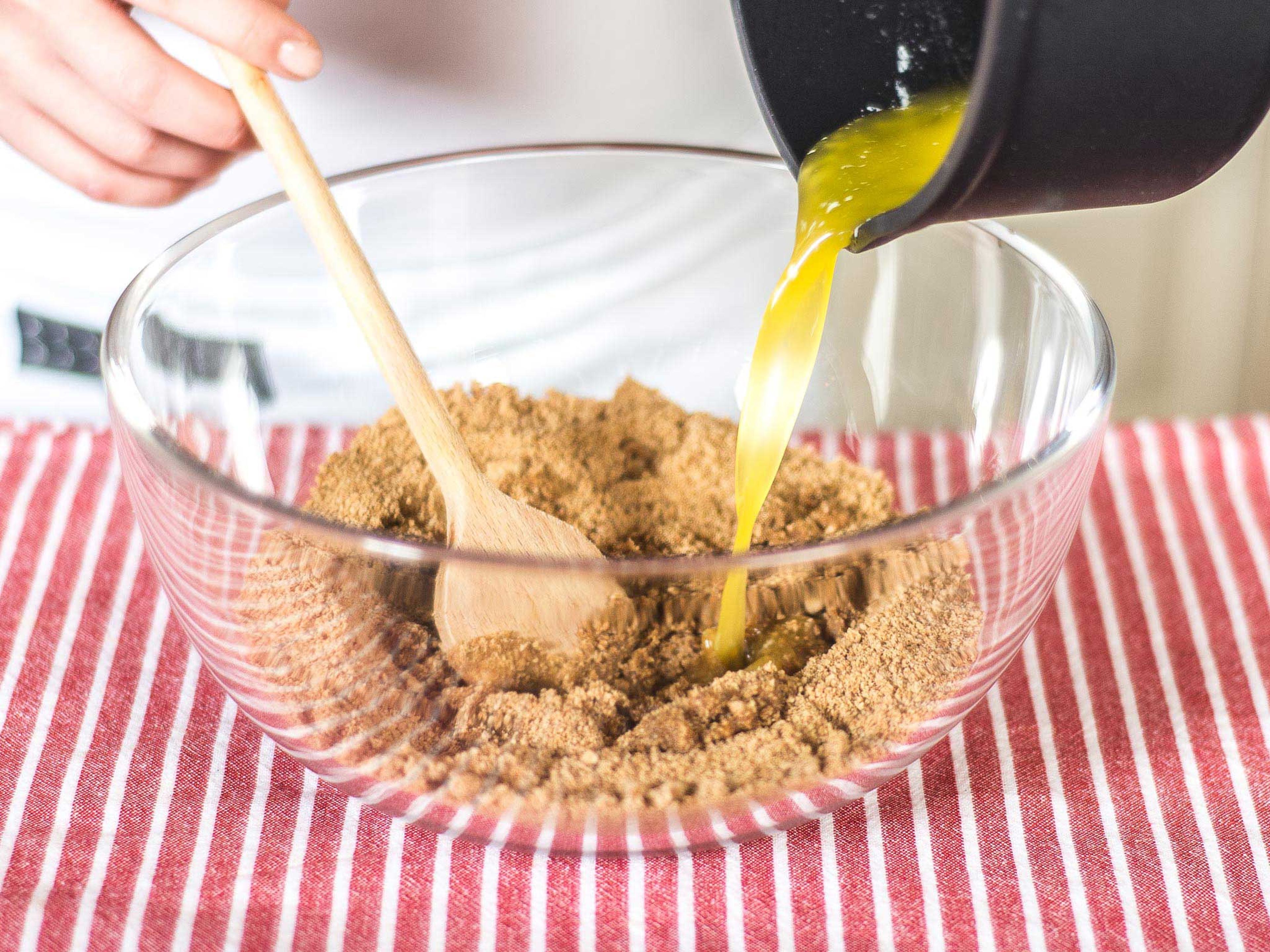 Preheat the oven to 180°C/ 350°F. To make the crust, finely pulse whole wheat graham crackers in a food processor. Add zest of one orange and half a lemon. Melt butter and pour directly onto the crumbs, stirring to combine.