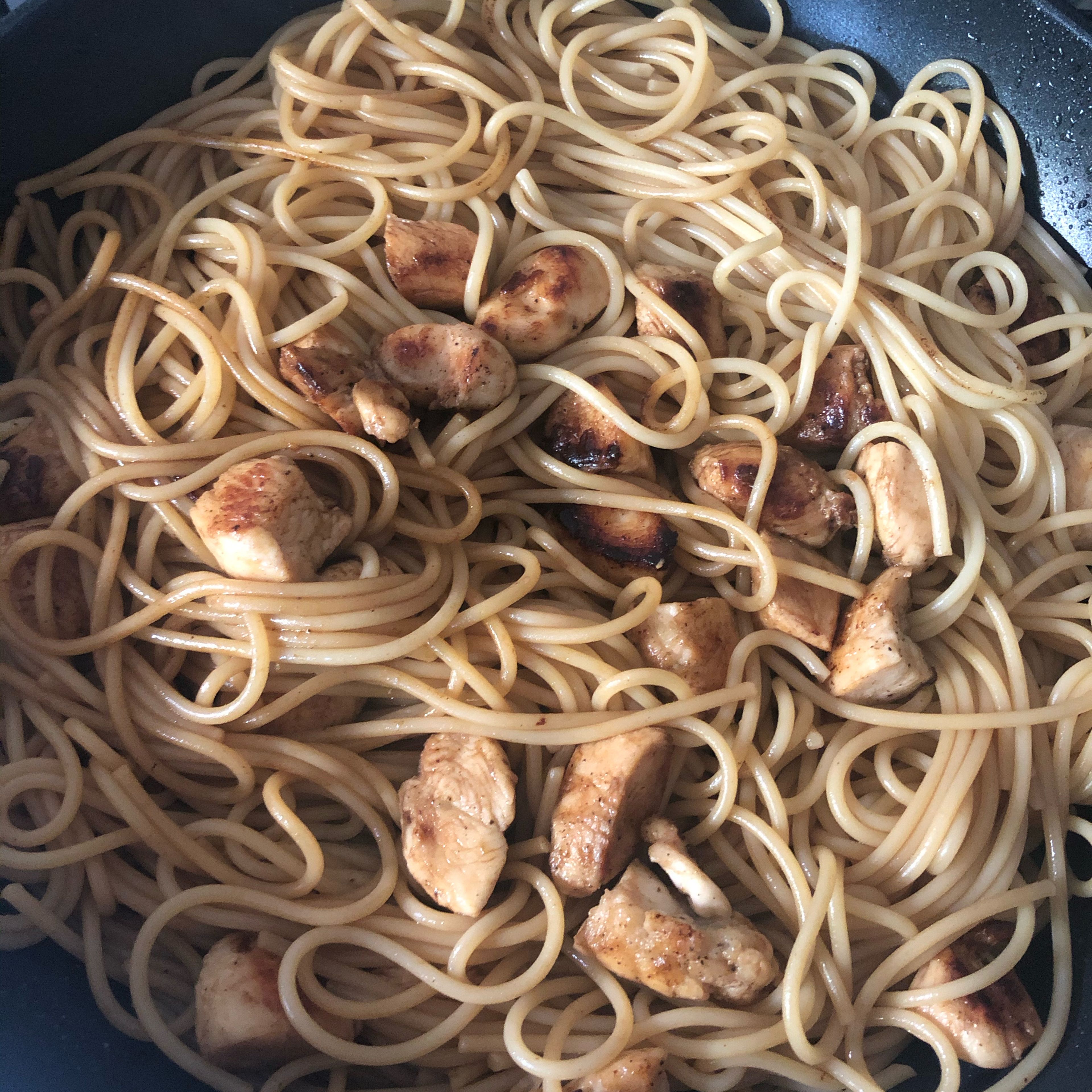 Take the pasta and put it in the fridge with the chicken. At the same time use the soy sauce to fry it all together. Fry it for about 2min shaking it constantly.