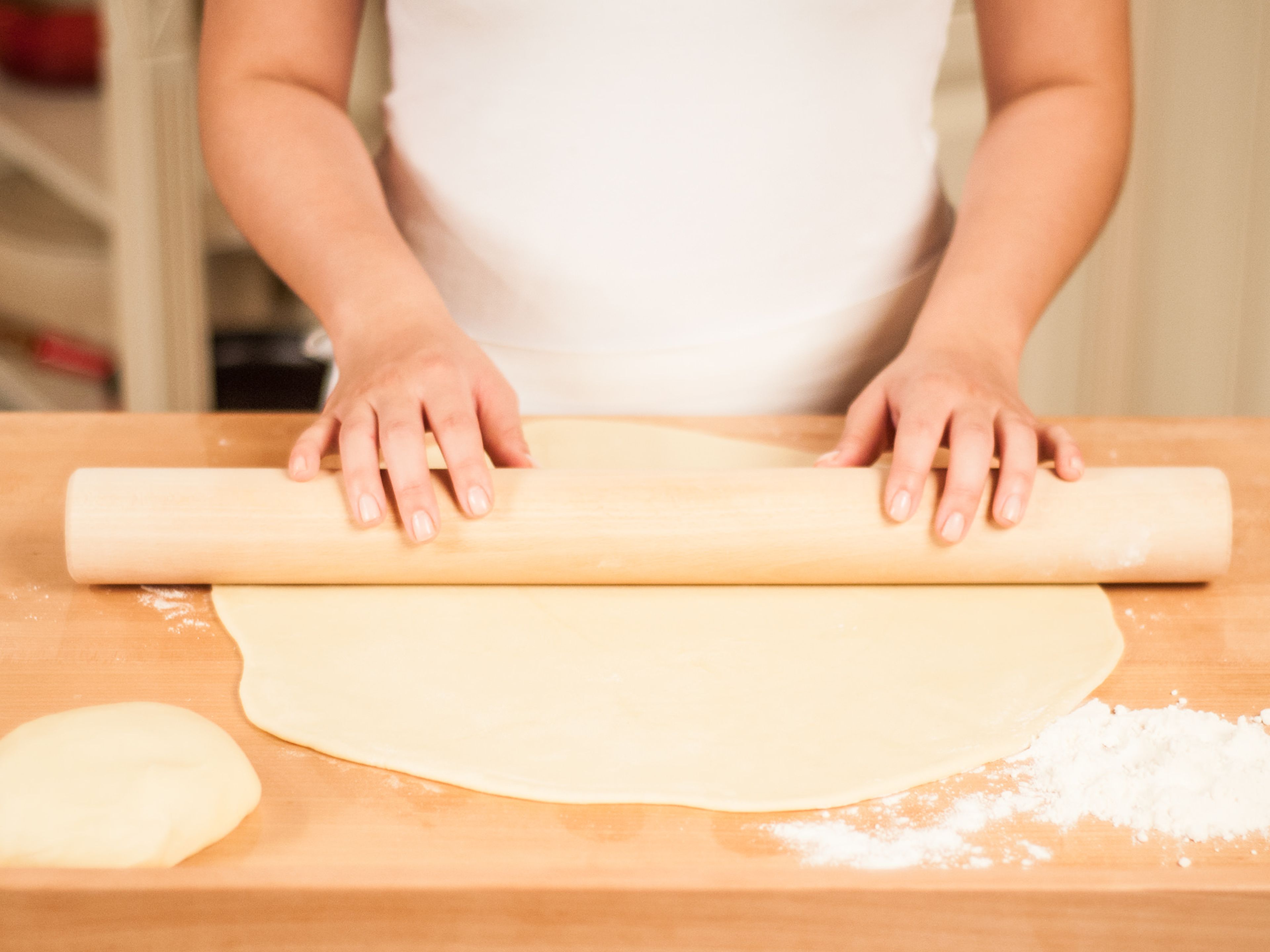 Now, on a lightly floured surface roll out two thirds of the dough into a large round to form the bottom of the pie. Roll out the remaining third into another round to form the top of the pie. Both rounds should be approx. 0.5cm thick.