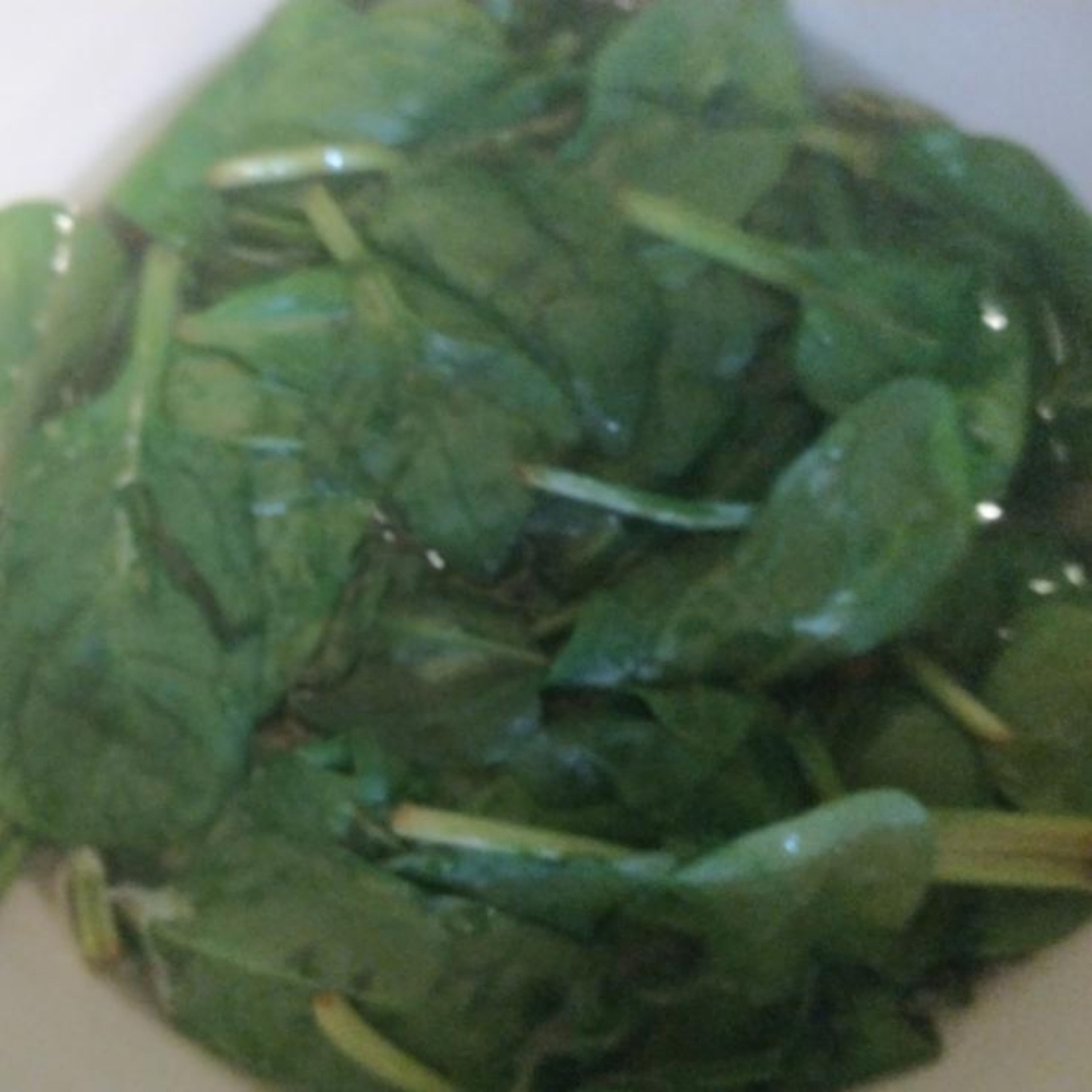 Place the spinach in a bowl, and pour over boiling water to cover. Let rest until wilted. Drain, and add the chilli, some nutmeg and soy sauce, then blend until smooth.