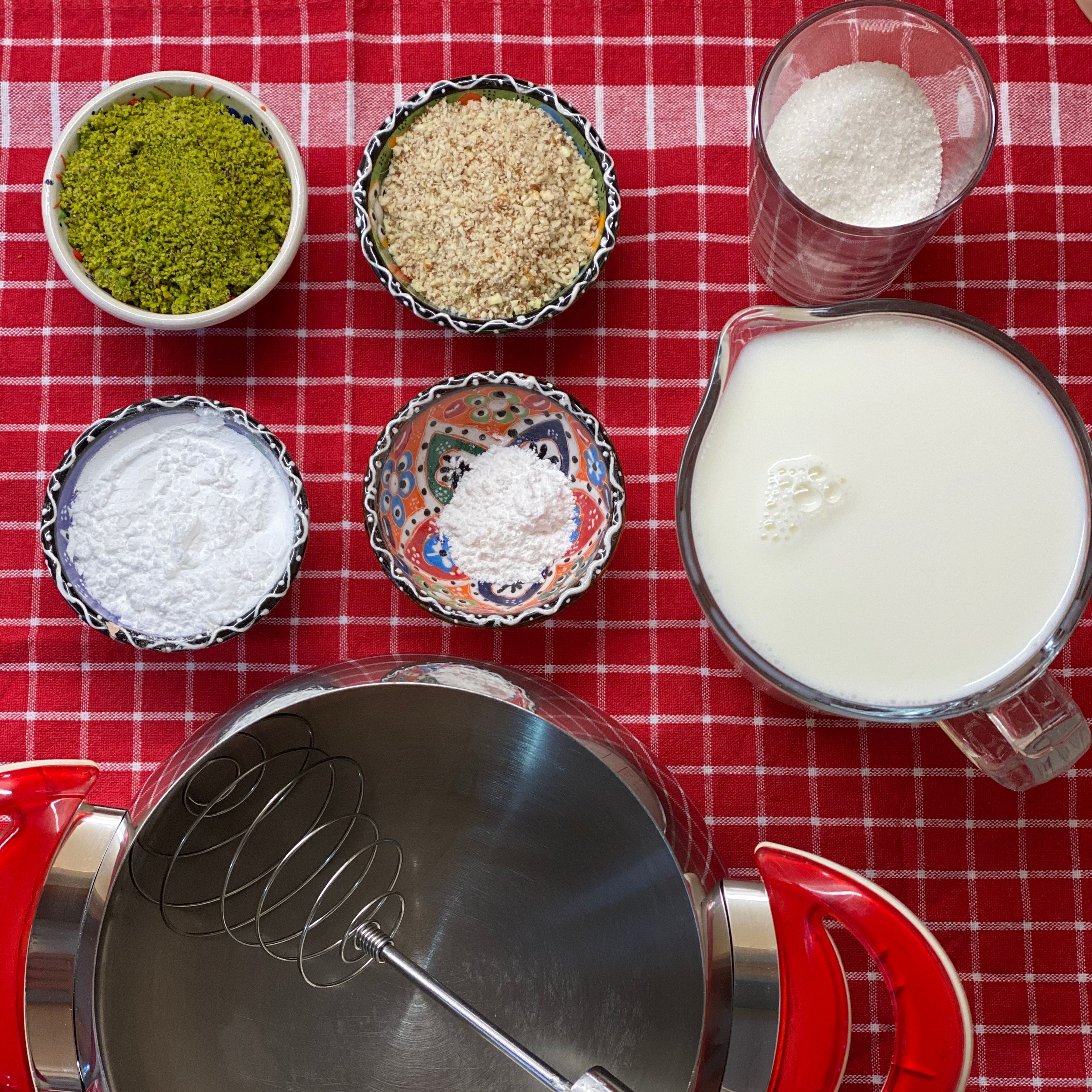 Add the milk, starch of wheat, sugar, vanilla, and chopped almonds to a saucepan.