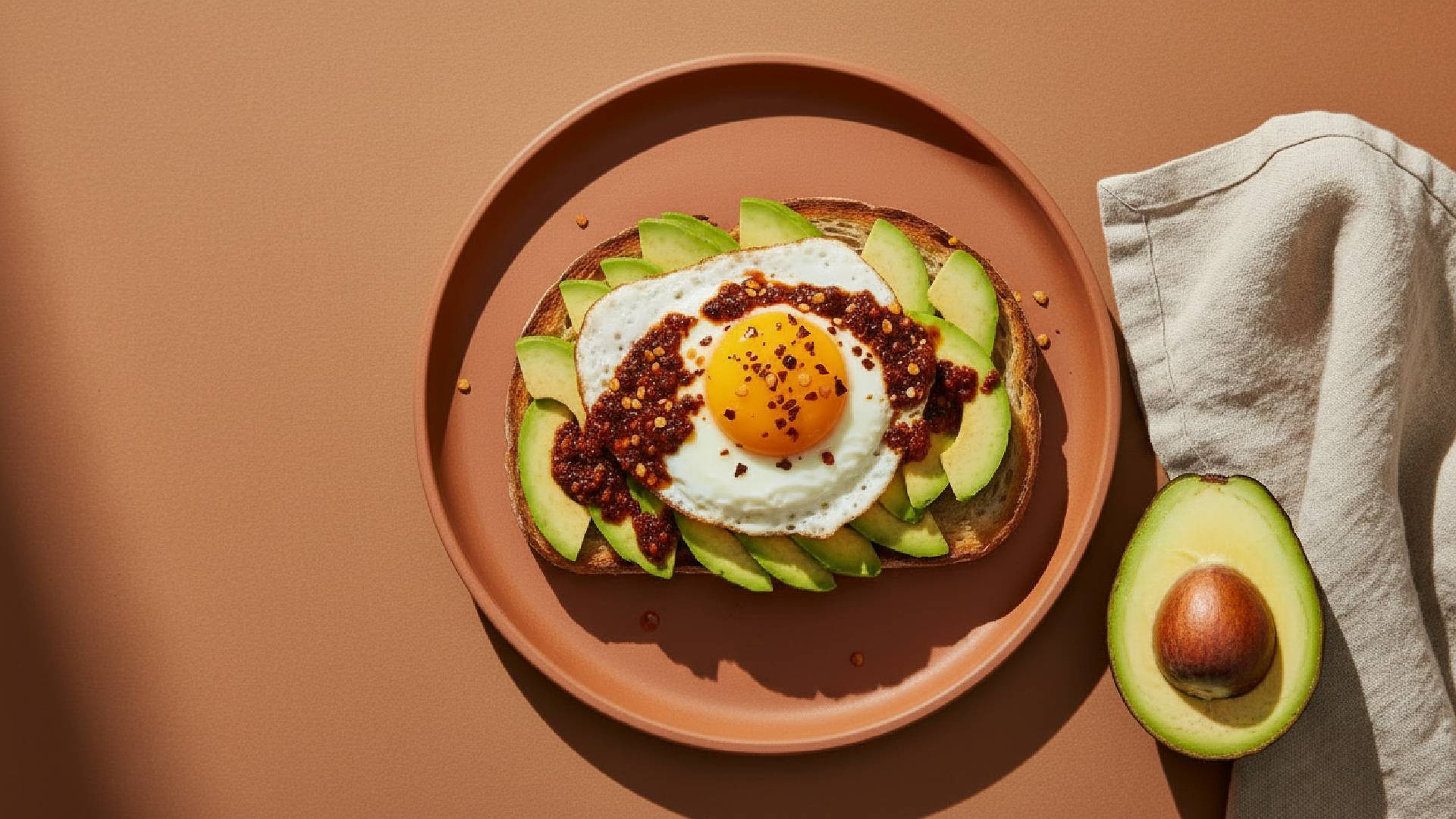 Pikantes Upgrade für den Frühstücksklassiker: Avocado-Toast mit Ei und Crispy Chili Oil