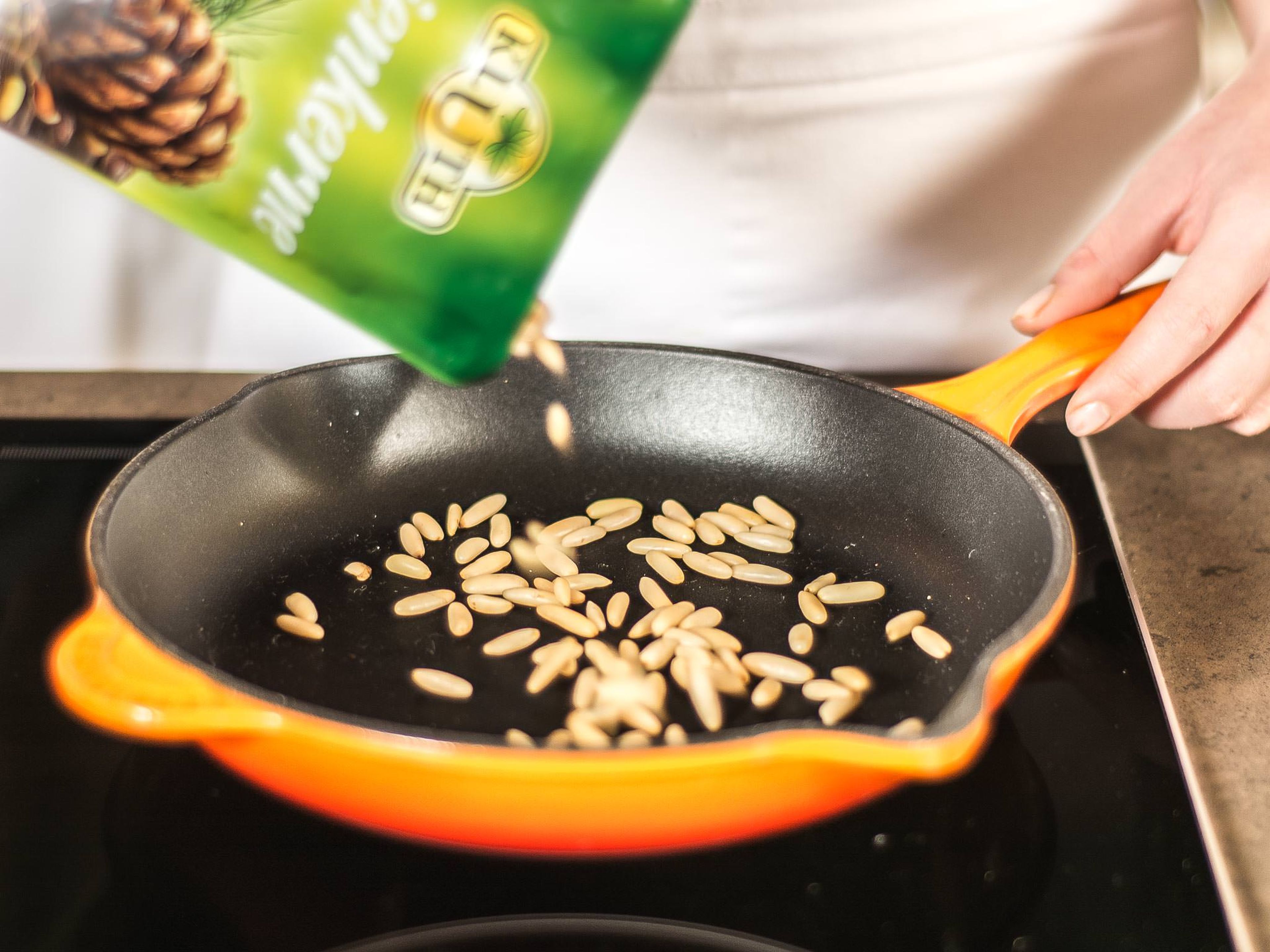 Roast the pine nuts in a pan until golden.
