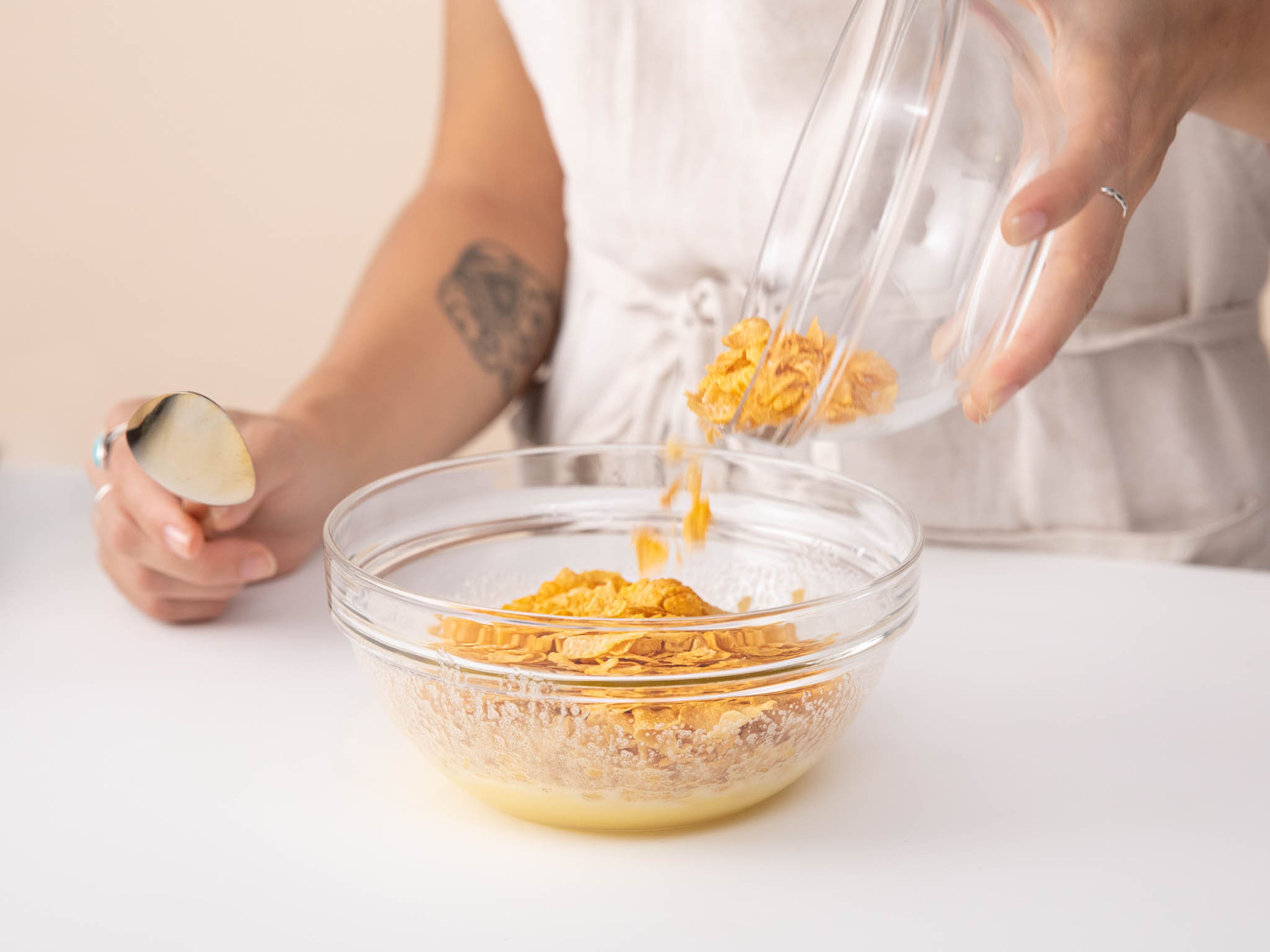Preheat oven to 160°C/325°F.  Whisk sugar and egg together in a bowl until well combined. Add cornflakes and mix until evenly coated with the mixture.