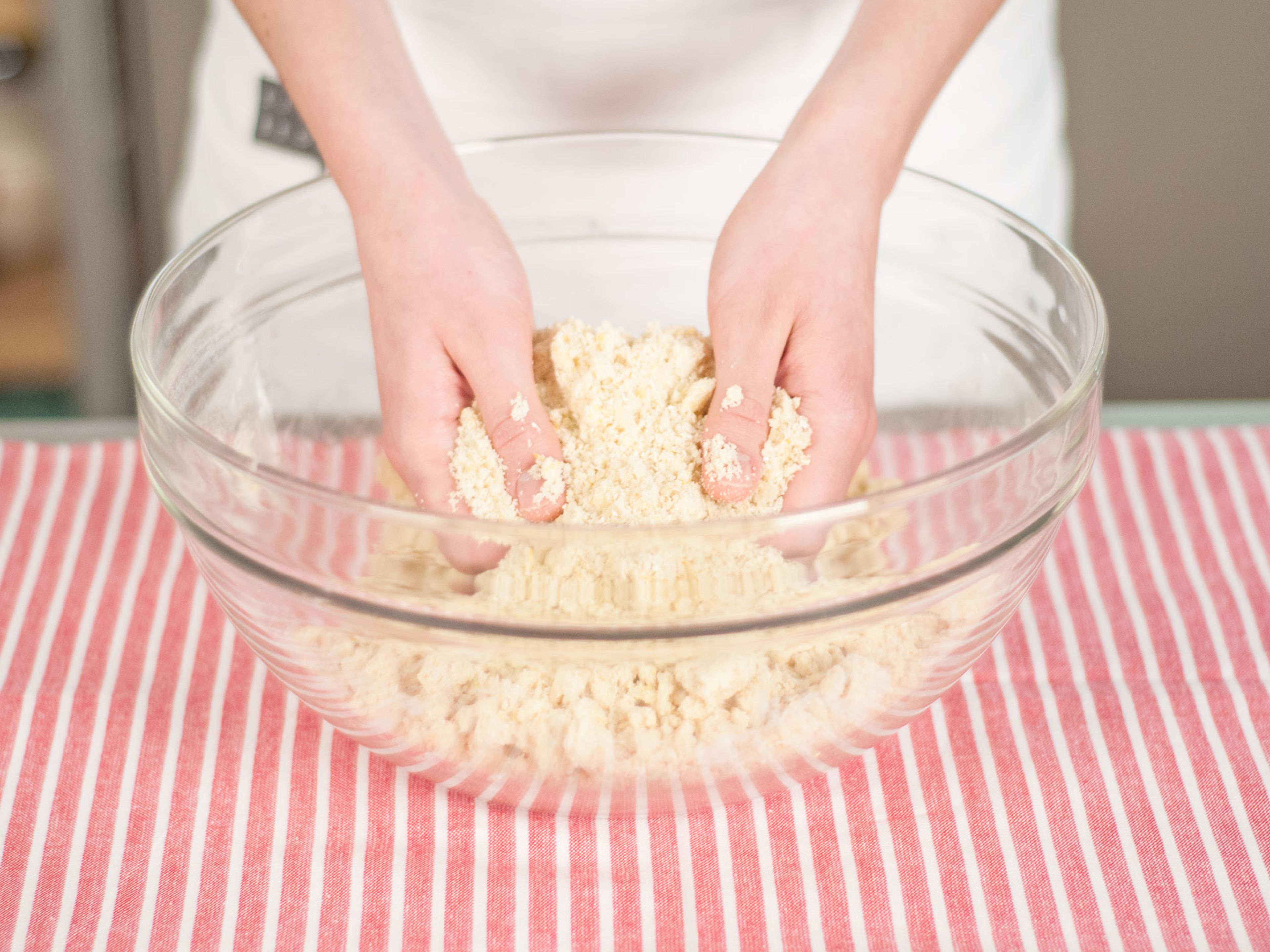 Roughly mix crumble topping using your hands.