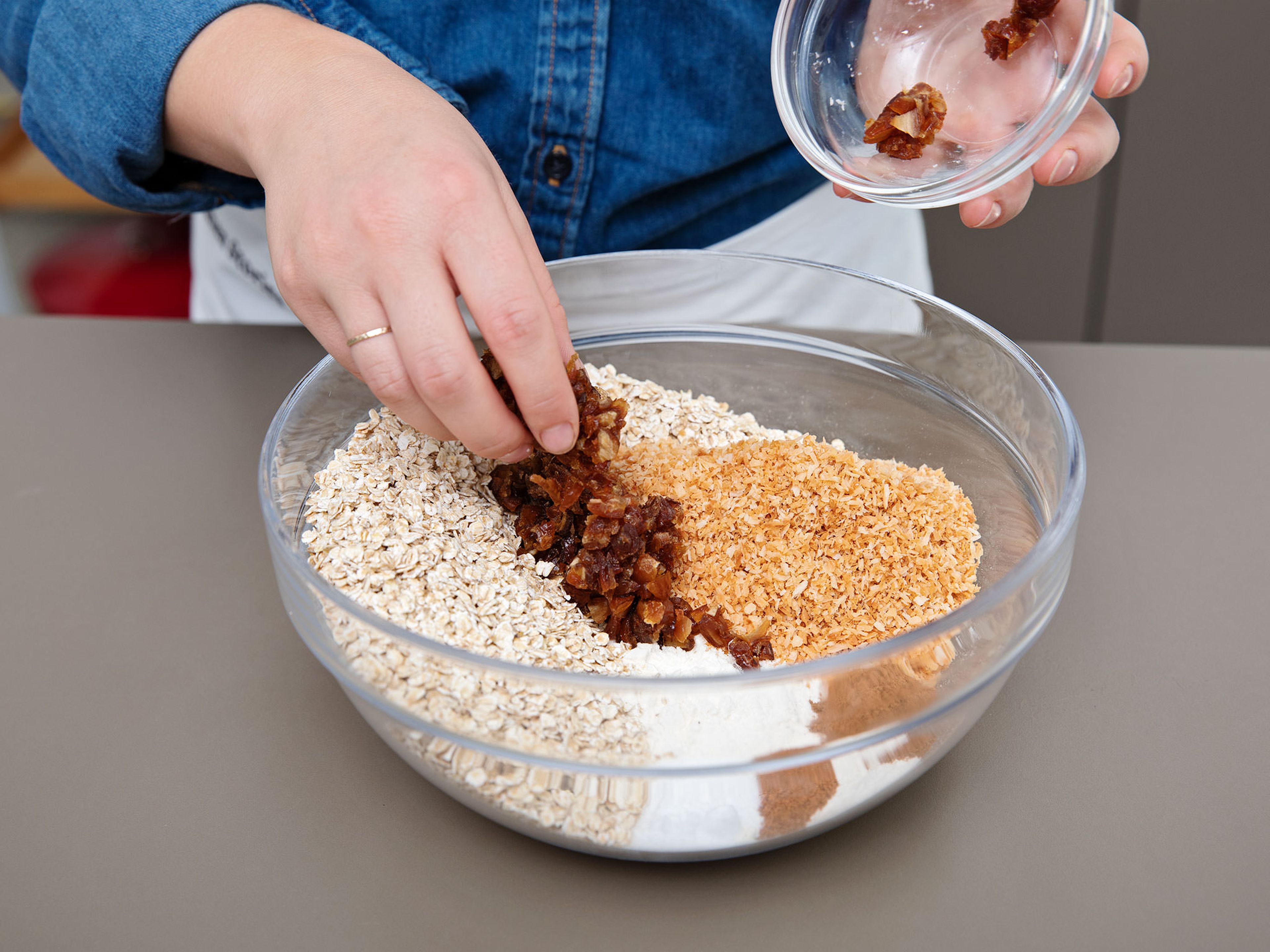 In a large bowl, whisk together the flour, cinnamon, nutmeg, salt, baking soda, rolled oats, chopped dates, and toasted coconut. Add mixture to the stand mixer and beat until just combined.