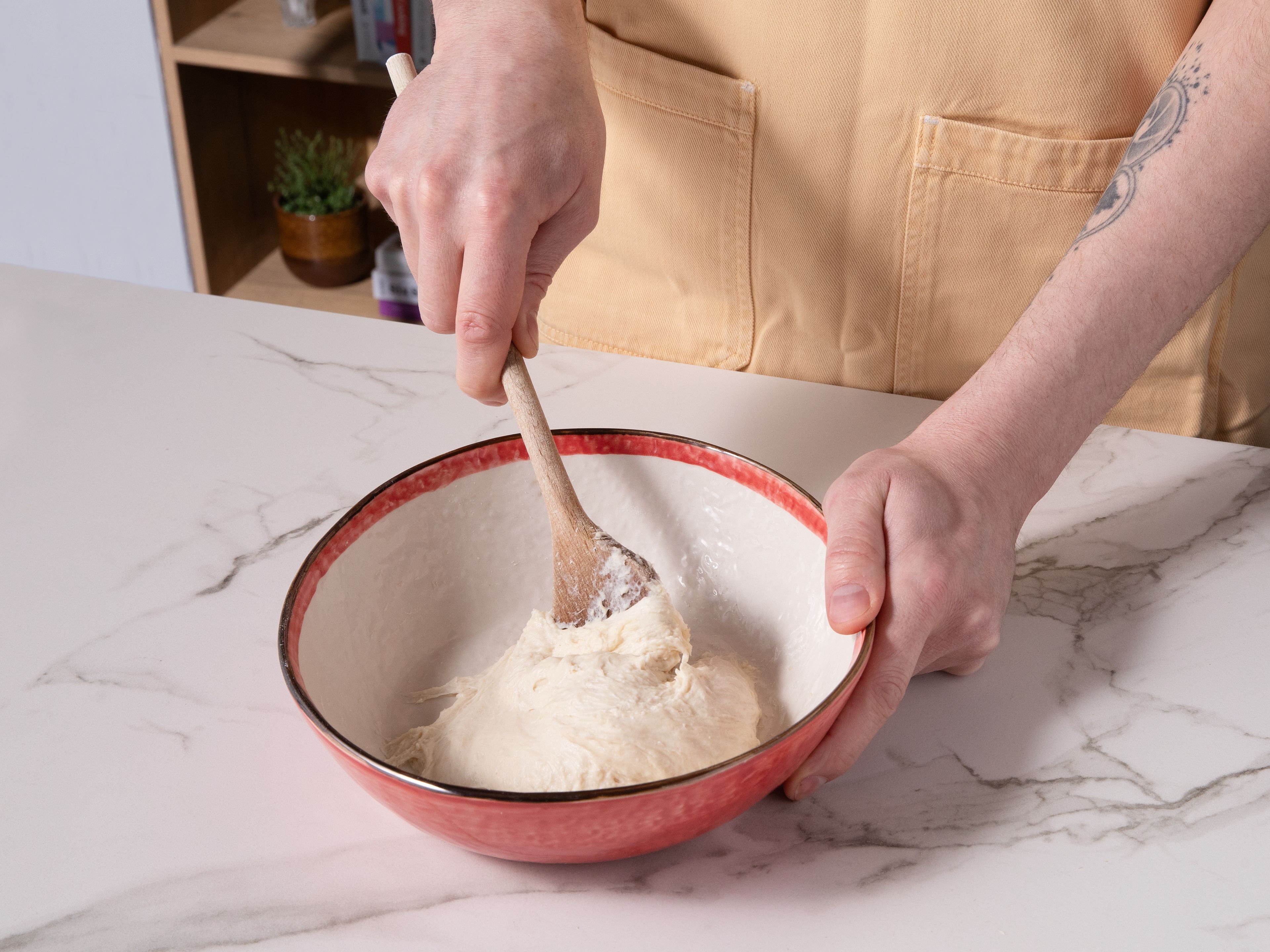 For air fryer focaccia, mix and dissolve yeast, sugar, and lukewarm water and set aside for approx. 15–20 min. until it's foamy. Then, sift in flour and salt, add oil and mix with a spoon until a smooth dough forms. Let rest for approx. 30 min. or more.