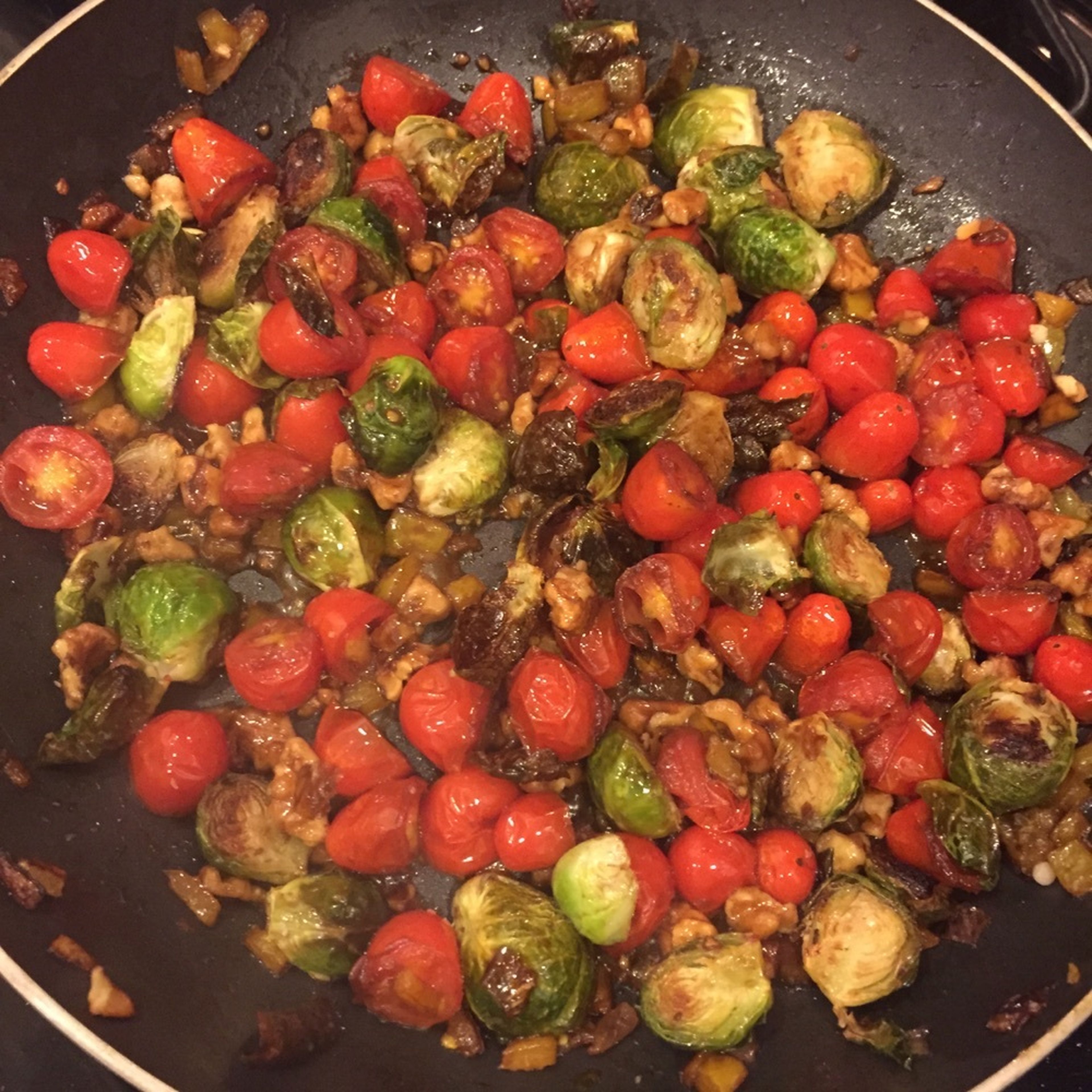 Add roasted walnuts and Brussels sprouts and continue to toss until balsamic vinegar has become slightly caramelized.