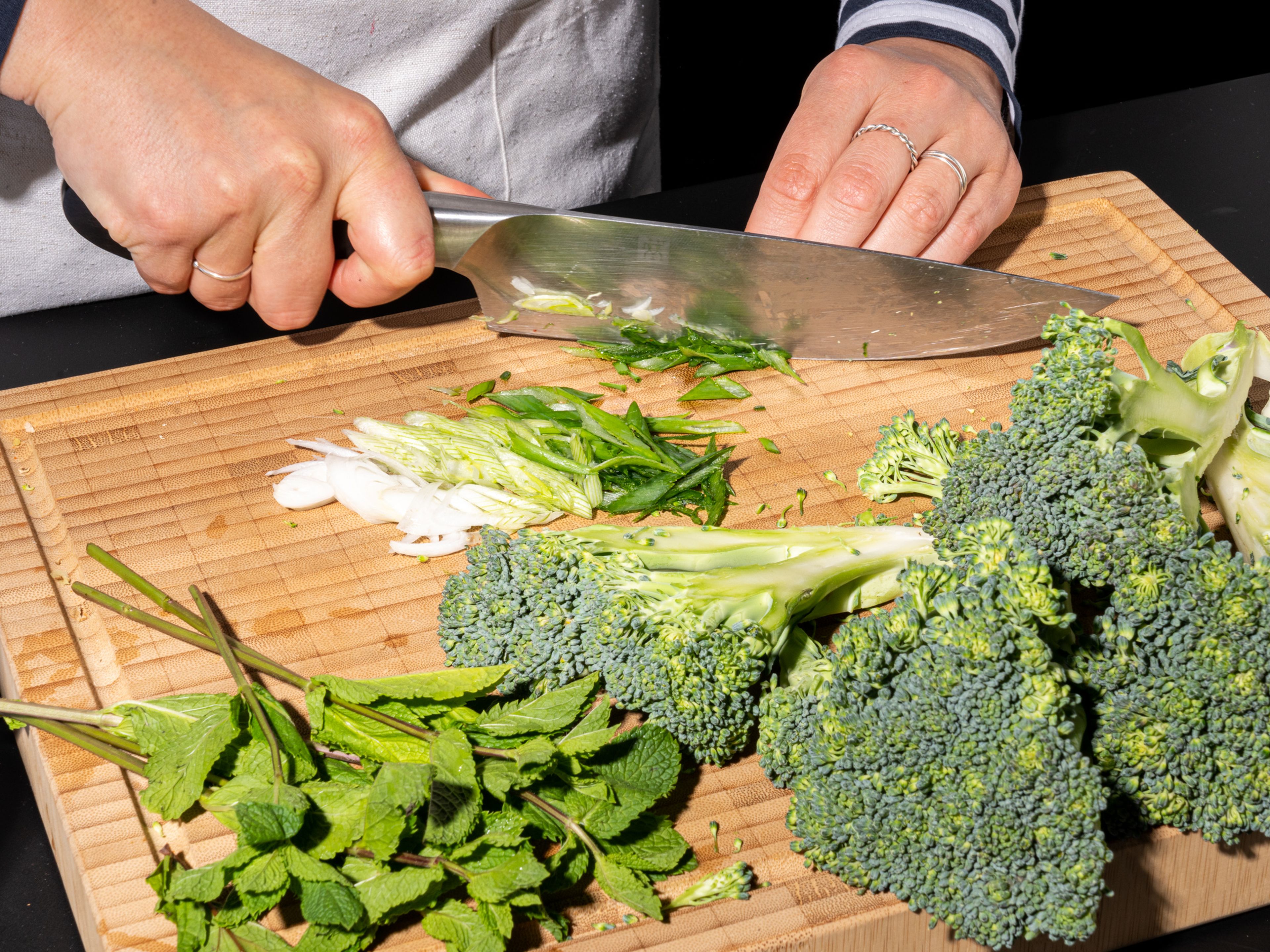 Preheat the oven or grill to 200°C/390°F. Slice off the bottom of the broccoli stem, then use a vegetable peeler to peel the woodier skin off the stem. Slice broccoli down the middle, then cut each half lengthwise into three pieces, so you have 6 "wedges". For the glaze, grate ginger and squeeze lime juice into a bowl with the hoisin sauce.  Mix well. Thinly slice scallions at an angle. Set aside.