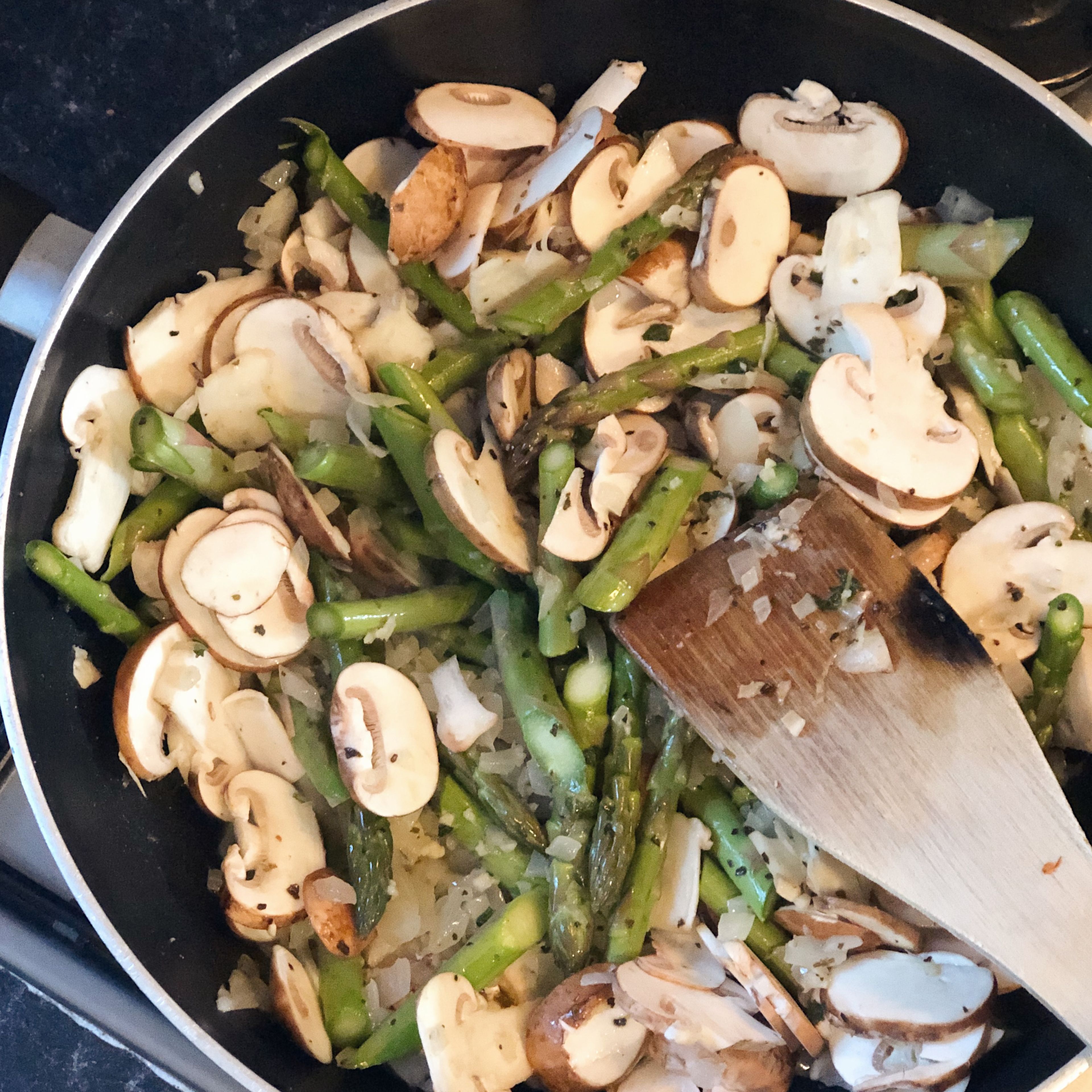 Add chopped mushrooms and asparagus to wok and fry on medium heat for 5 minutes.