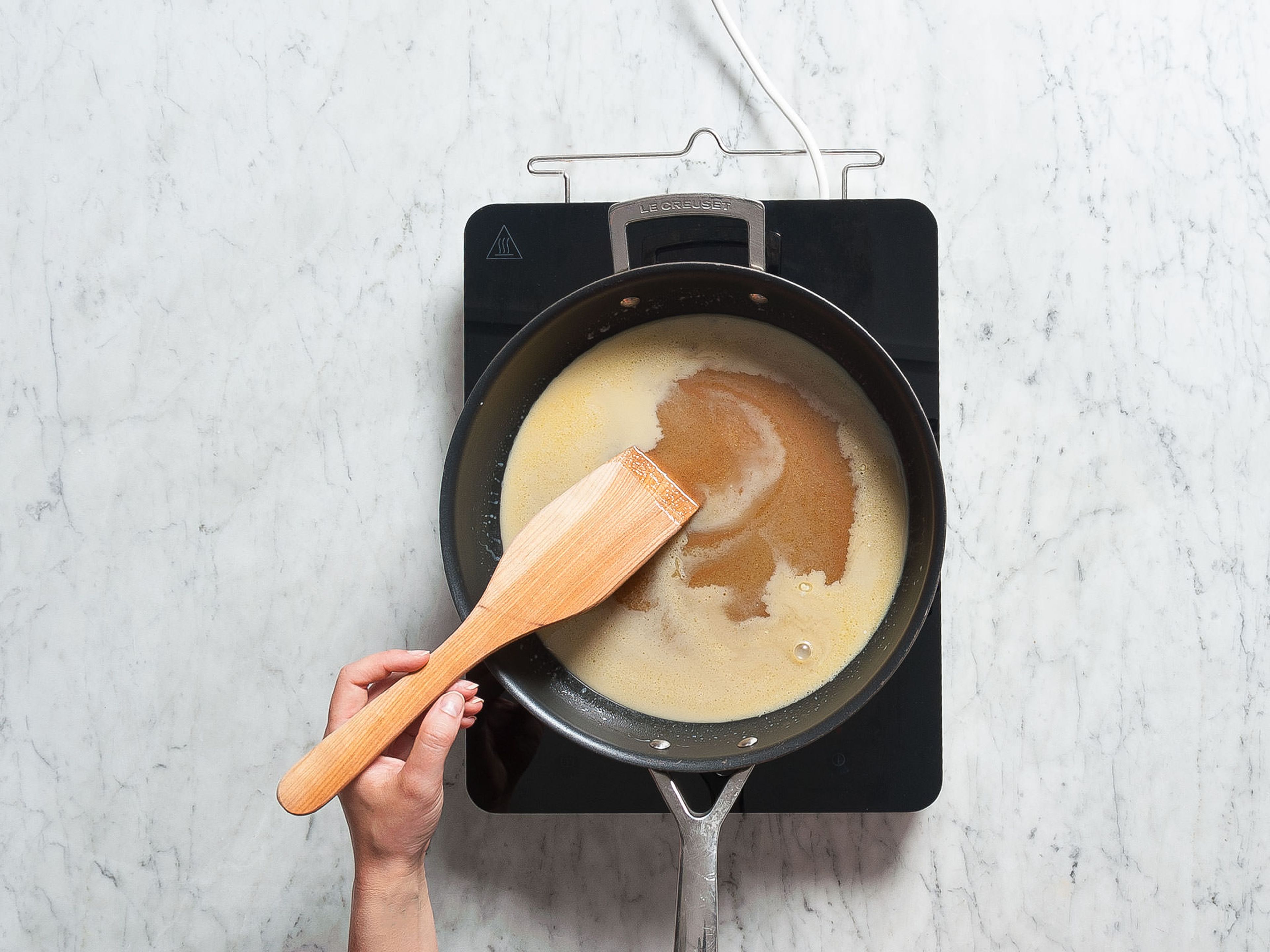 Add cane sugar, sugar, heavy cream, and vanilla extract to a nonstick pan set over medium heat and cook until sugar dissolves. Reduce heat and continue to simmer on low heat for approx. 15 min., without stirring. Add cold butter and swirl pan until butter is melted; don’t stir.