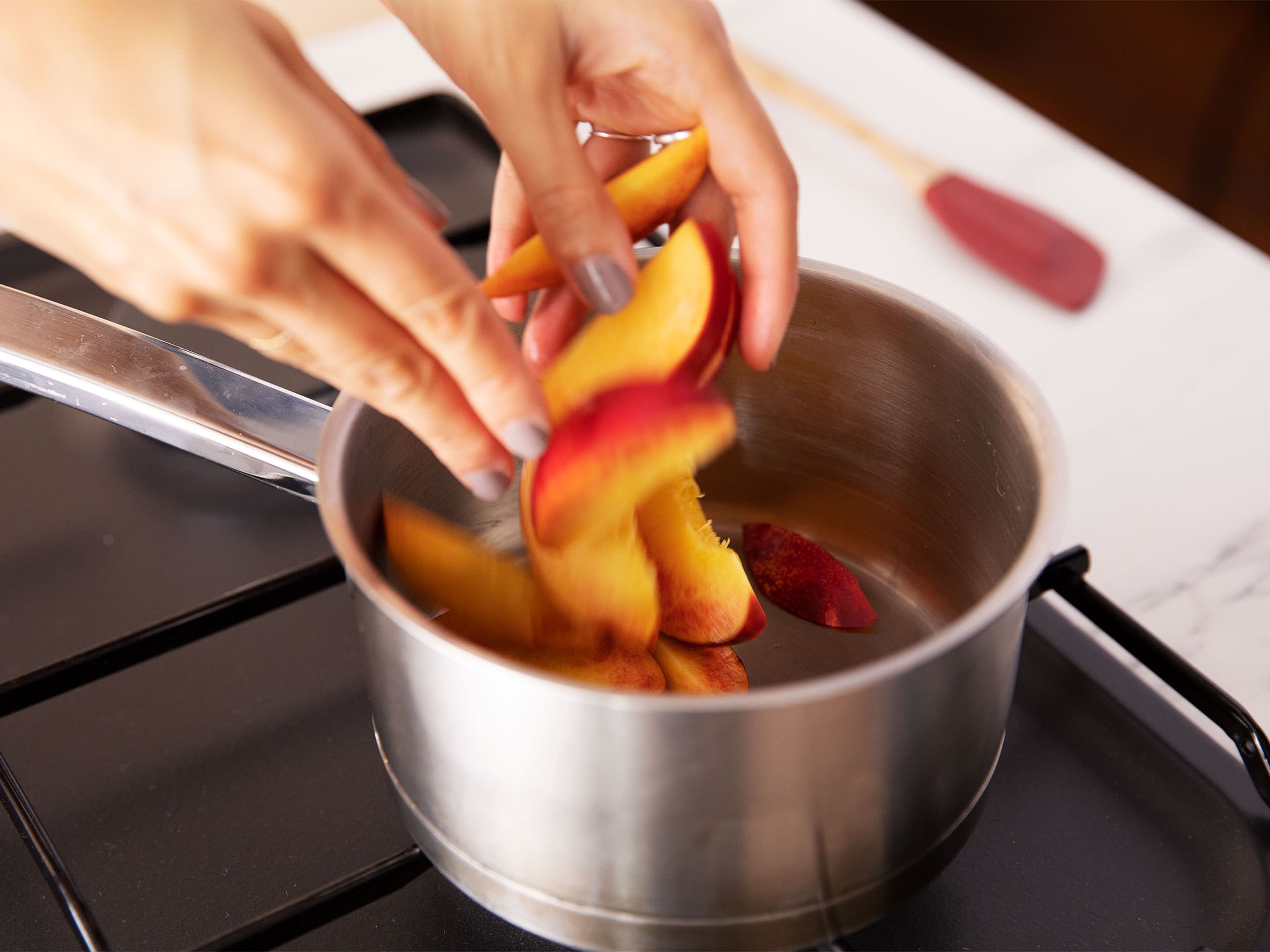 Core and cut the nectarine into slices. Cook in a pot over low heat until softened.