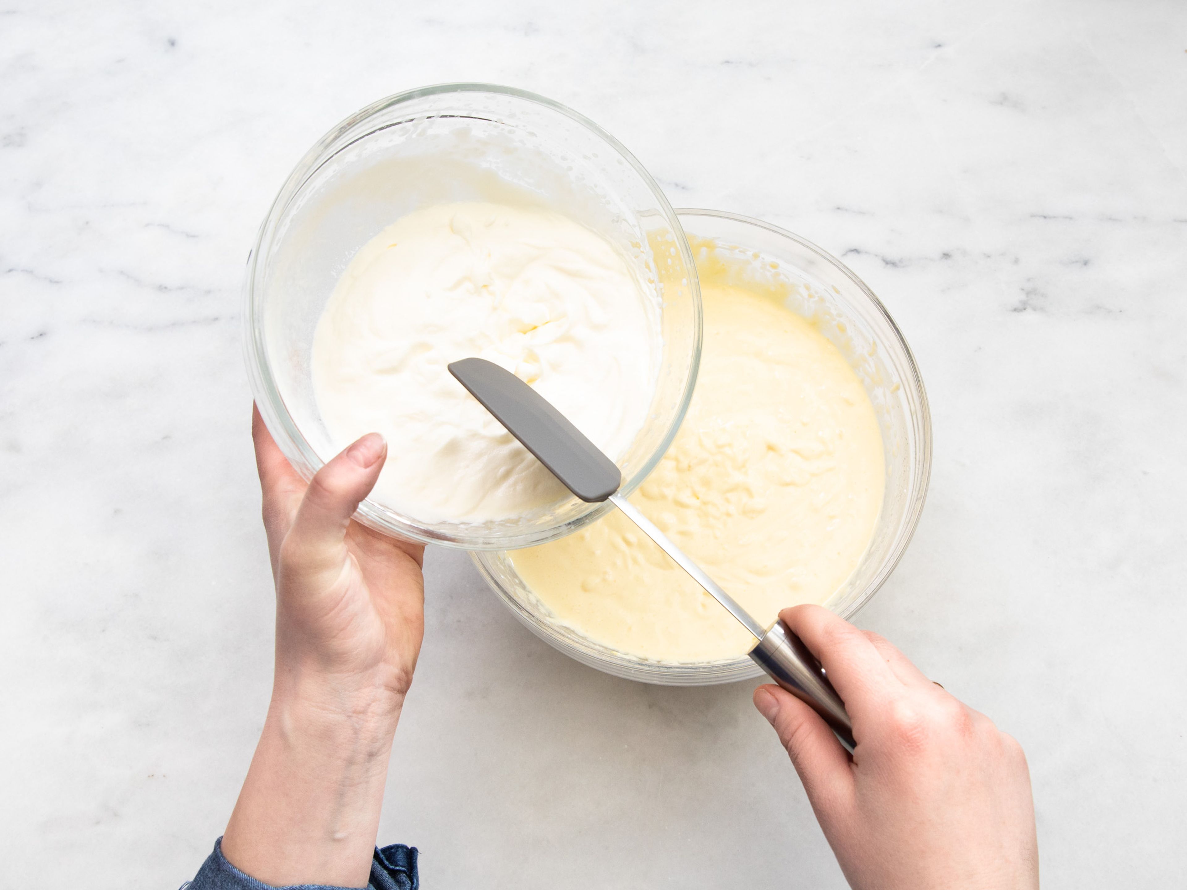 In a large bowl, beat the heavy cream until stiff and set aside. Mix in the egg yolks with quark, crème fraîche, vanilla extract, vanilla pudding powder, starch, lemon zest, lemon juice, and remaining sugar. Carefully fold in the beaten egg whites and whipped cream.