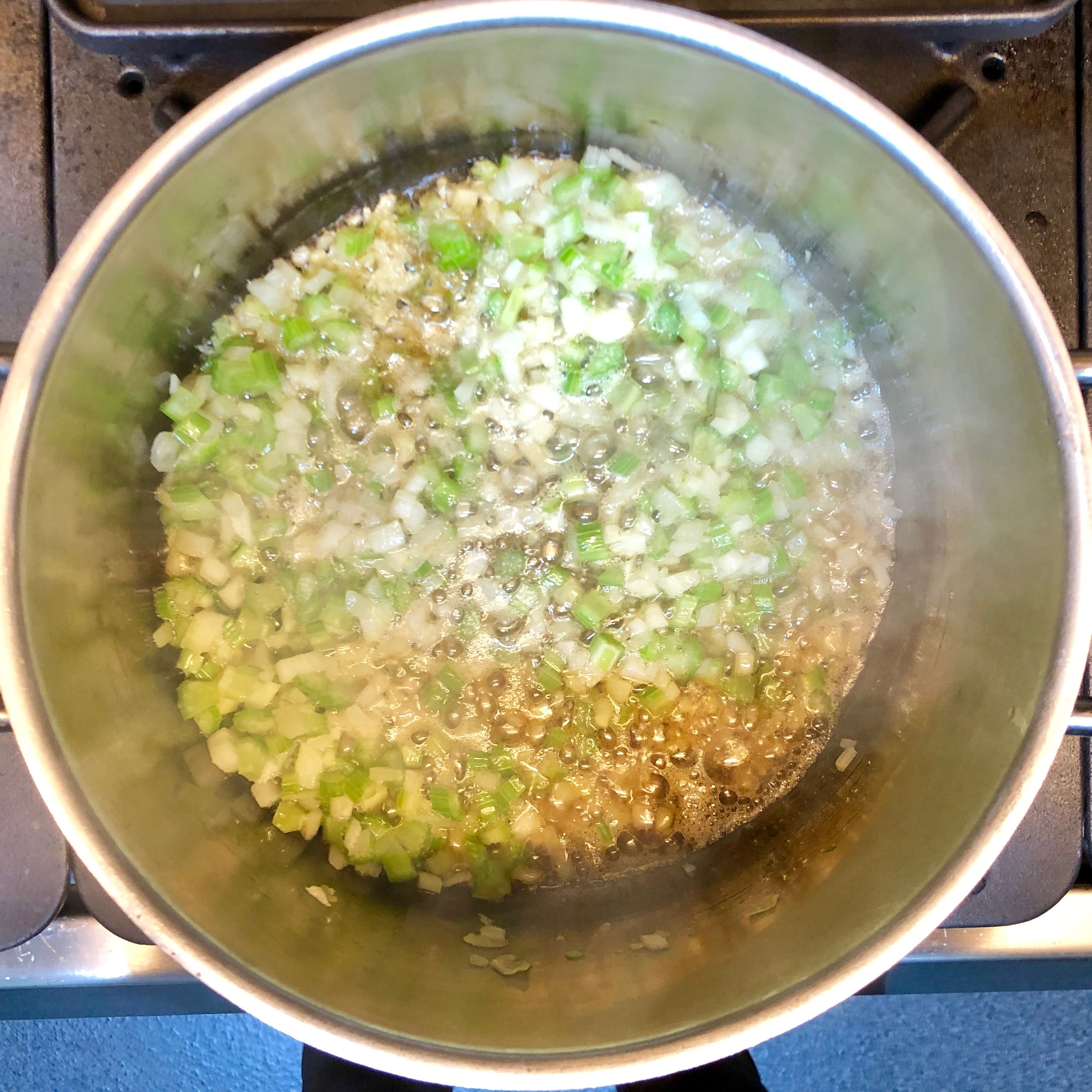 Heat sesame oil in a stockpot. Add already cut onion, garlic, celery and ginger. Cook until soft but not brown. About 3 minutes.