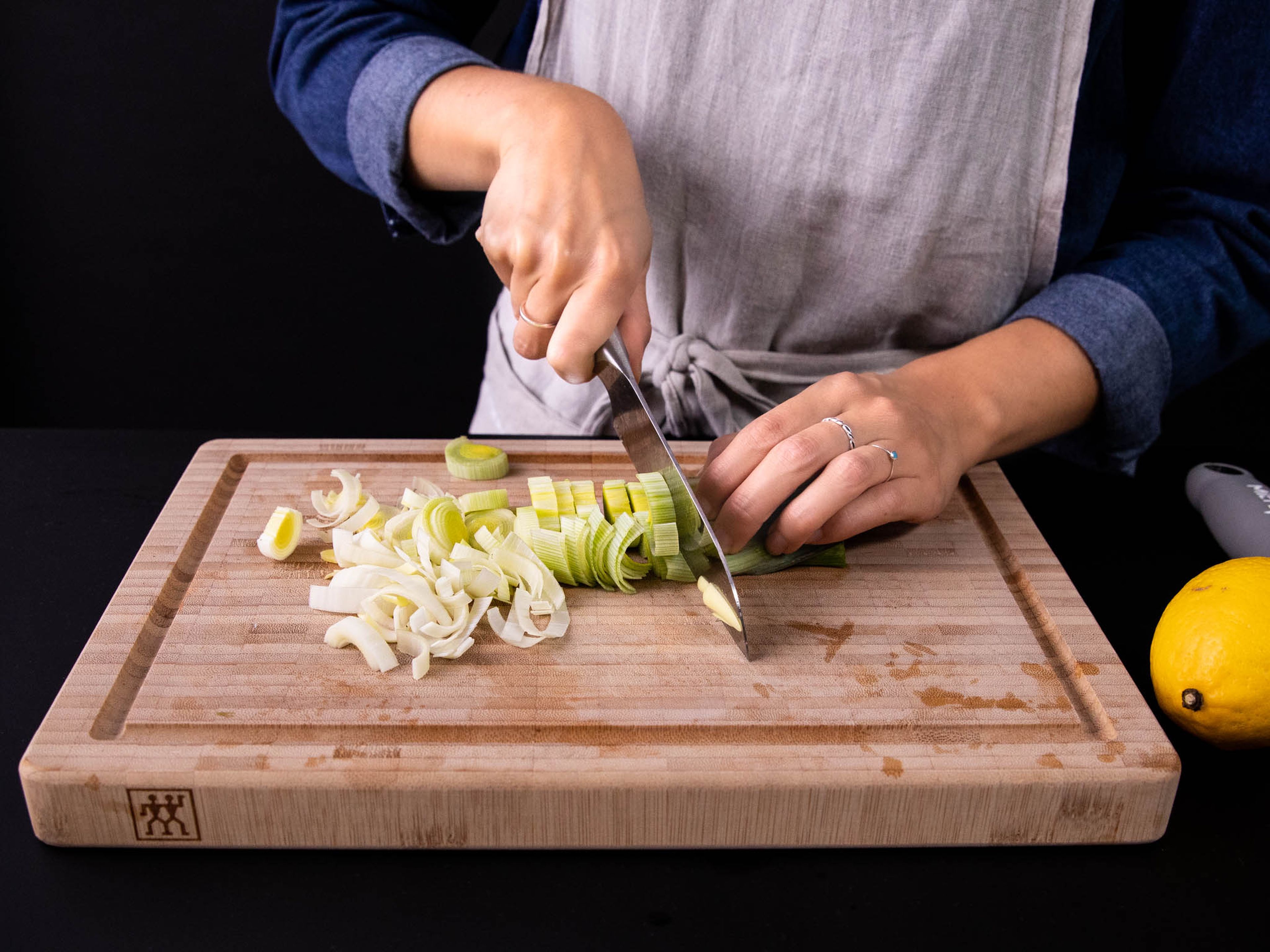 Thinly slice fennel and leek, saving any fennel fronds for garnish. Zest and juice lemon and set aside. Add leek to a large bowl of water and swish around, then let settle. The dirt will fall to the bottom, and the clean leek will float. Remove leek and drain.