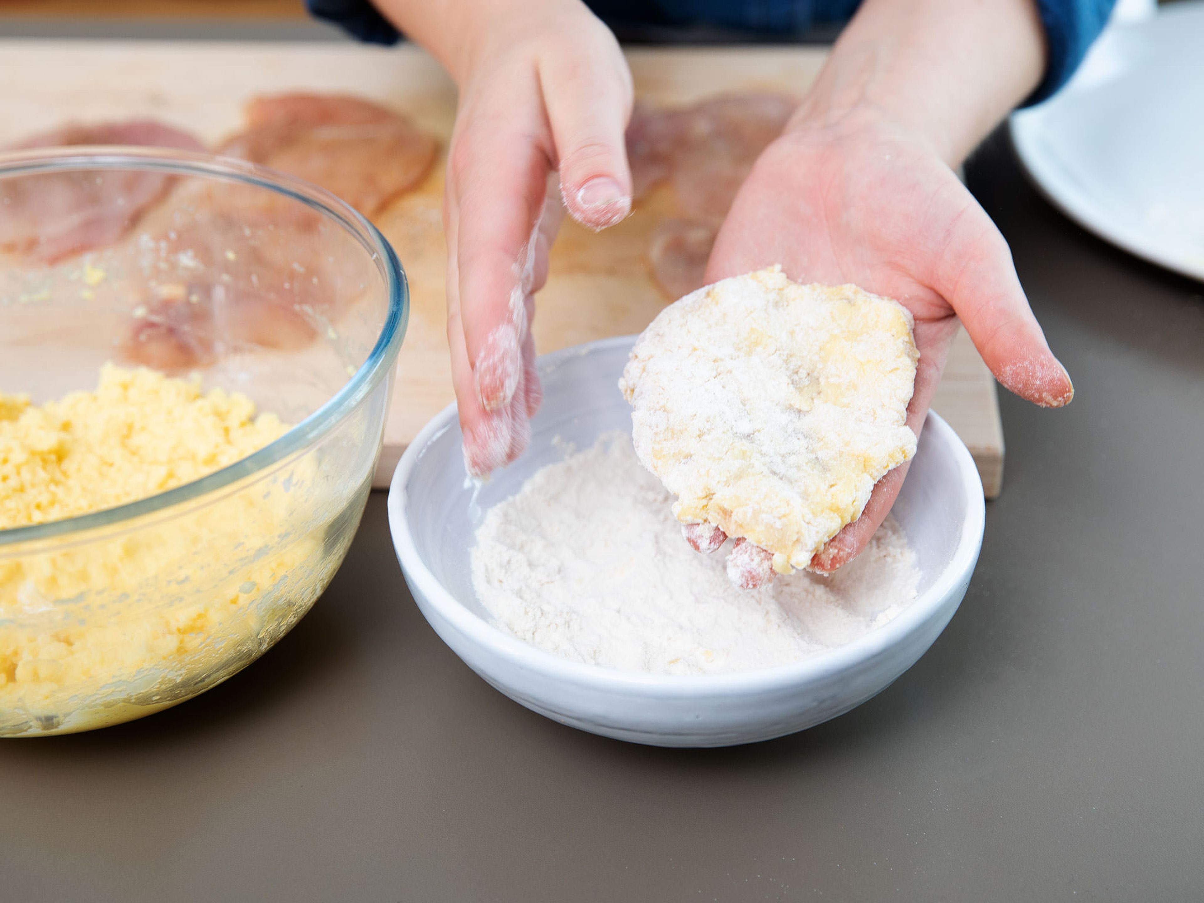 Cut chicken breast into desired pieces. Transfer to plastic wrap and cover with plastic wrap. Using a meat tenderizer, pound the chicken breasts until as thin as possible and set aside. Crack eggs into a bowl and whisk. Add grated Parmesan cheese and stir to combine. Add flour to another bowl. Remove chicken breast from plastic foil and season with salt and pepper on both sides. Dredge in flour, then in Parmesan-egg coating and in flour again.