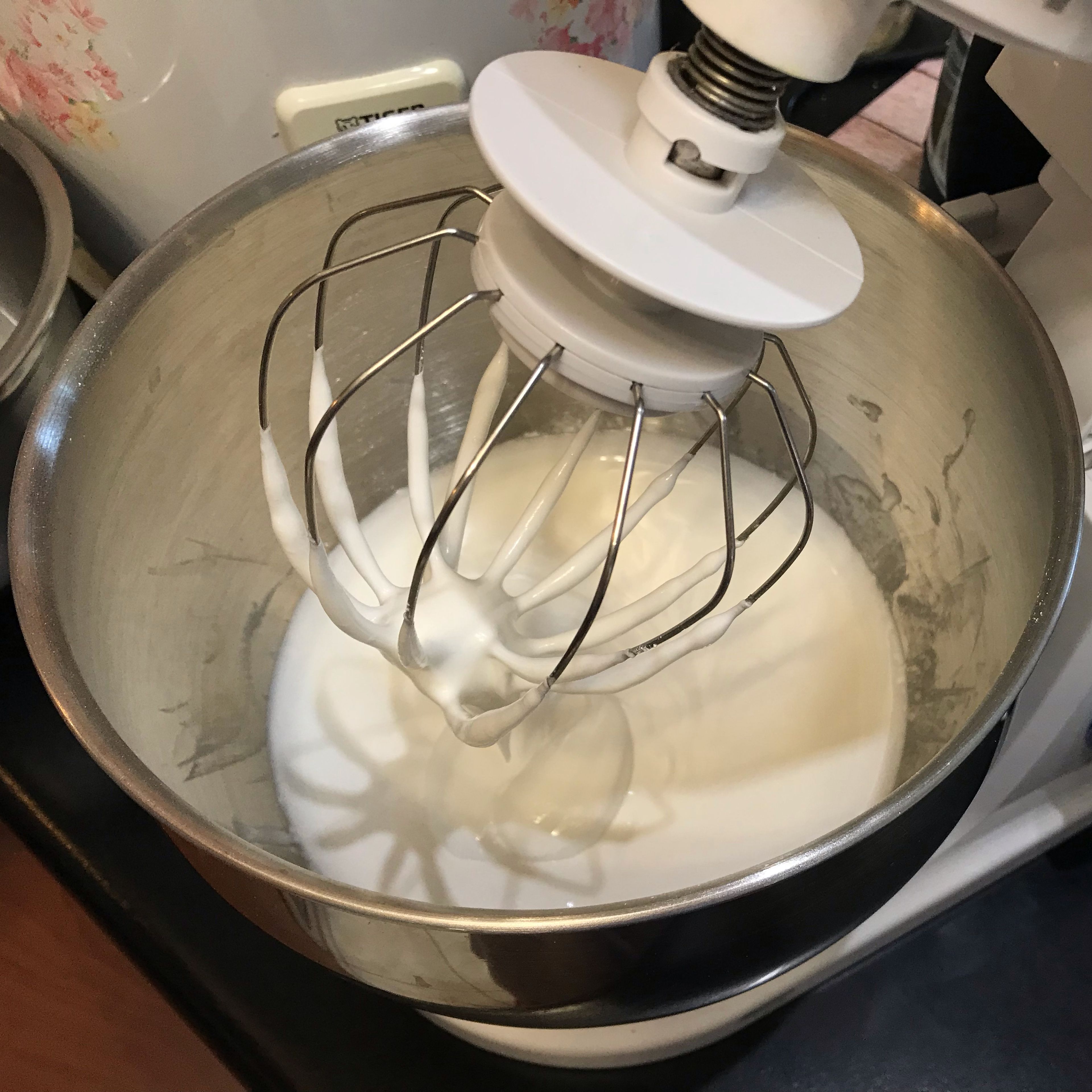 Place room-temperature pasteurised egg whites and powdered sugar in a stand mixer bowl. Attach the whisk and combine ingredients on low, then whip on high for 5 minutes.