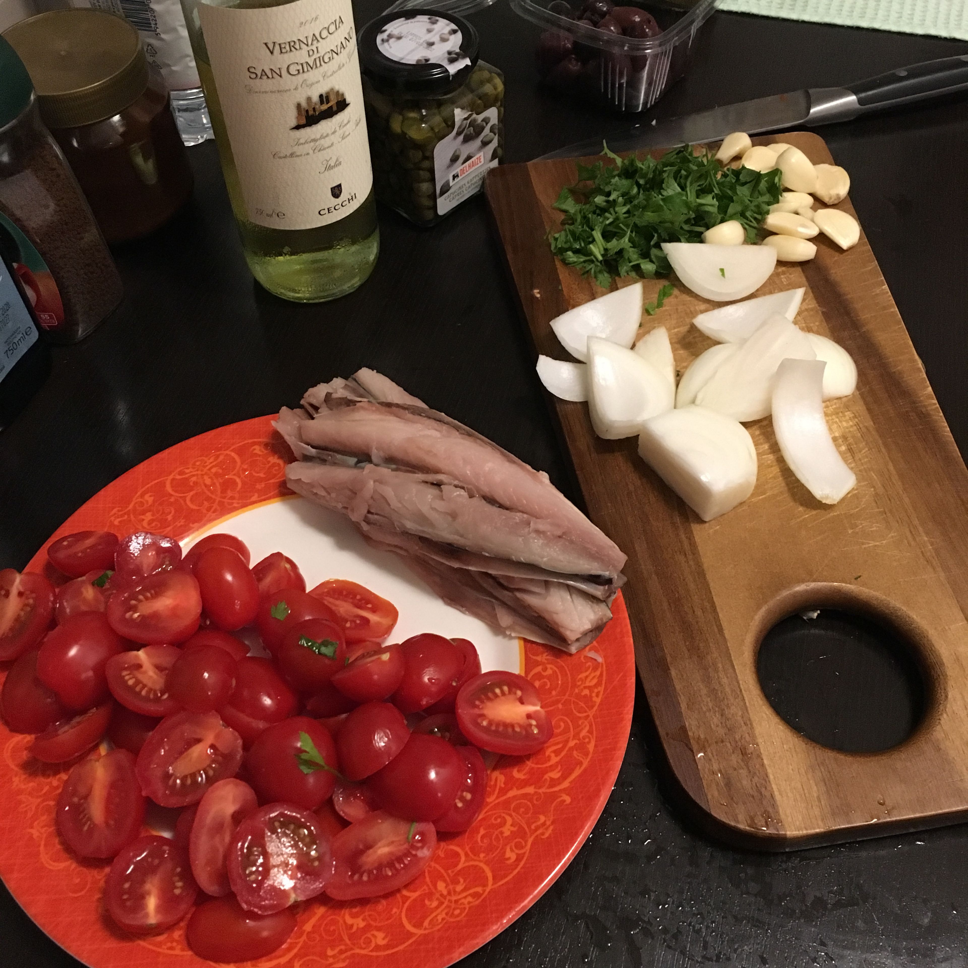 Cut fish, tomatoes, garlic, onion, parsley