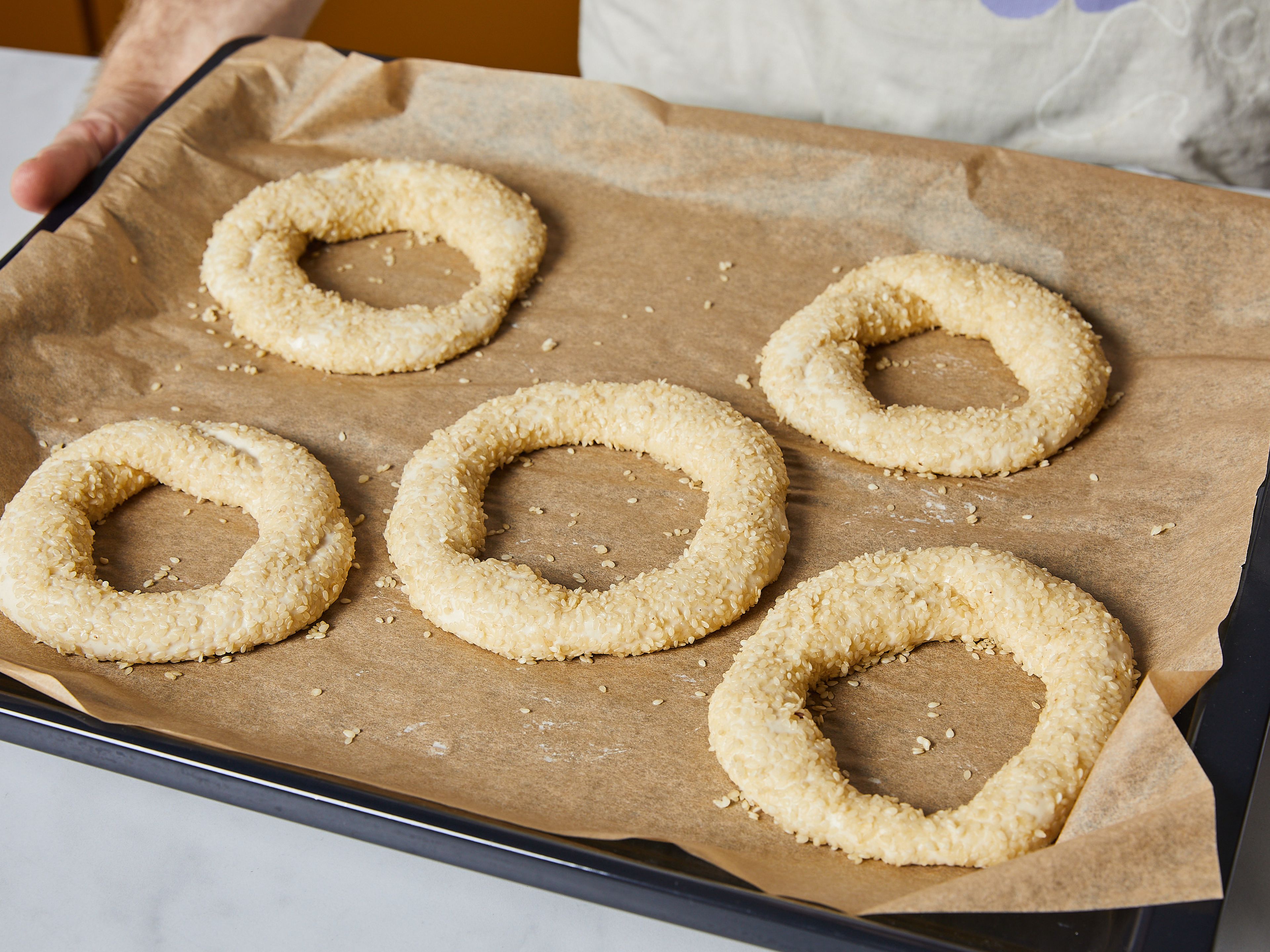 Add the simit to the oven and immediately reduce temperature to 230°C/440°F. Bake for a total of 20-25 min., rotating the sheets halfway through. Remove from oven and serve warm with cream cheese, butter or plain.