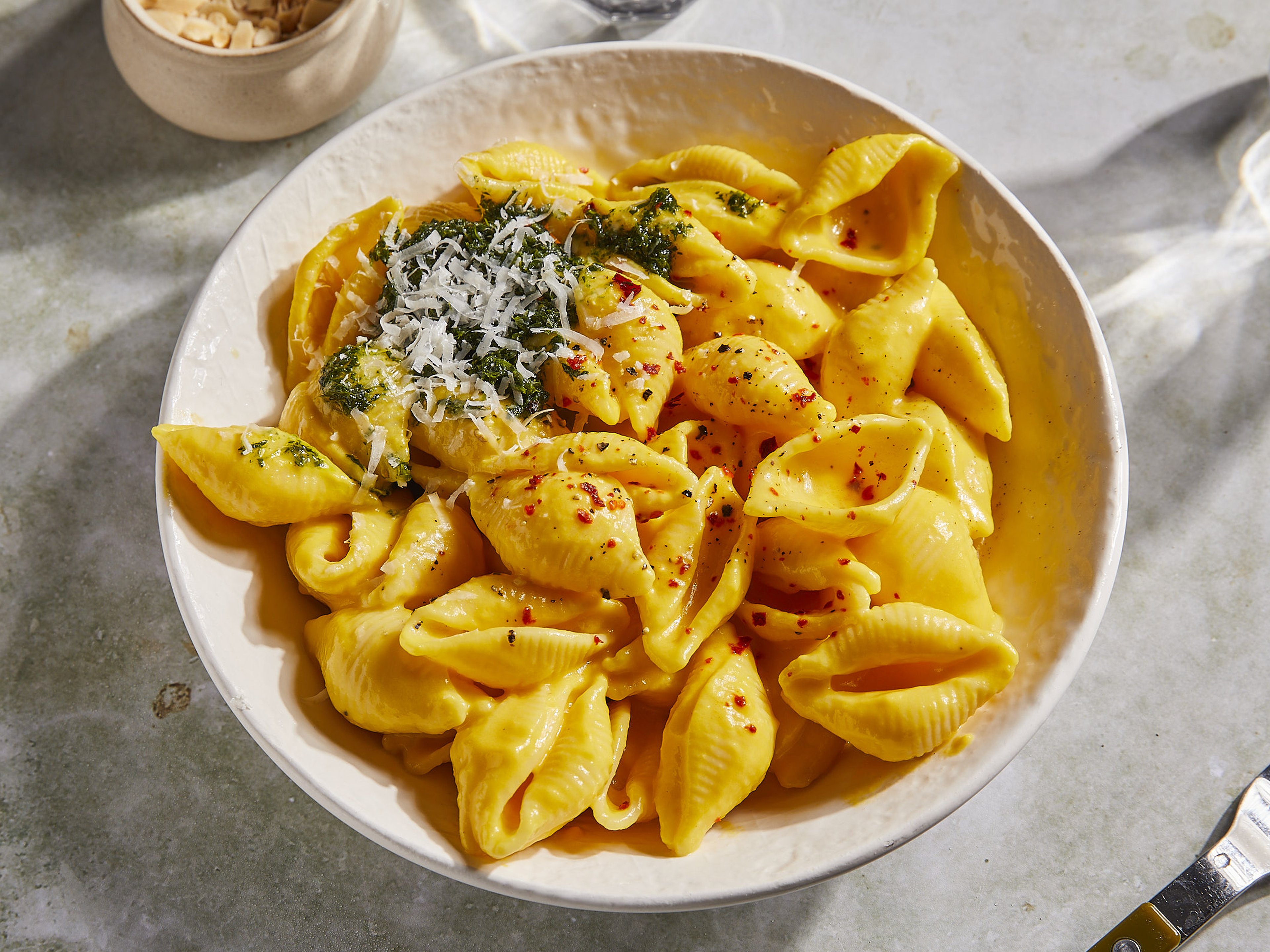 Creamy pasta with carrot sauce and carrot top pesto