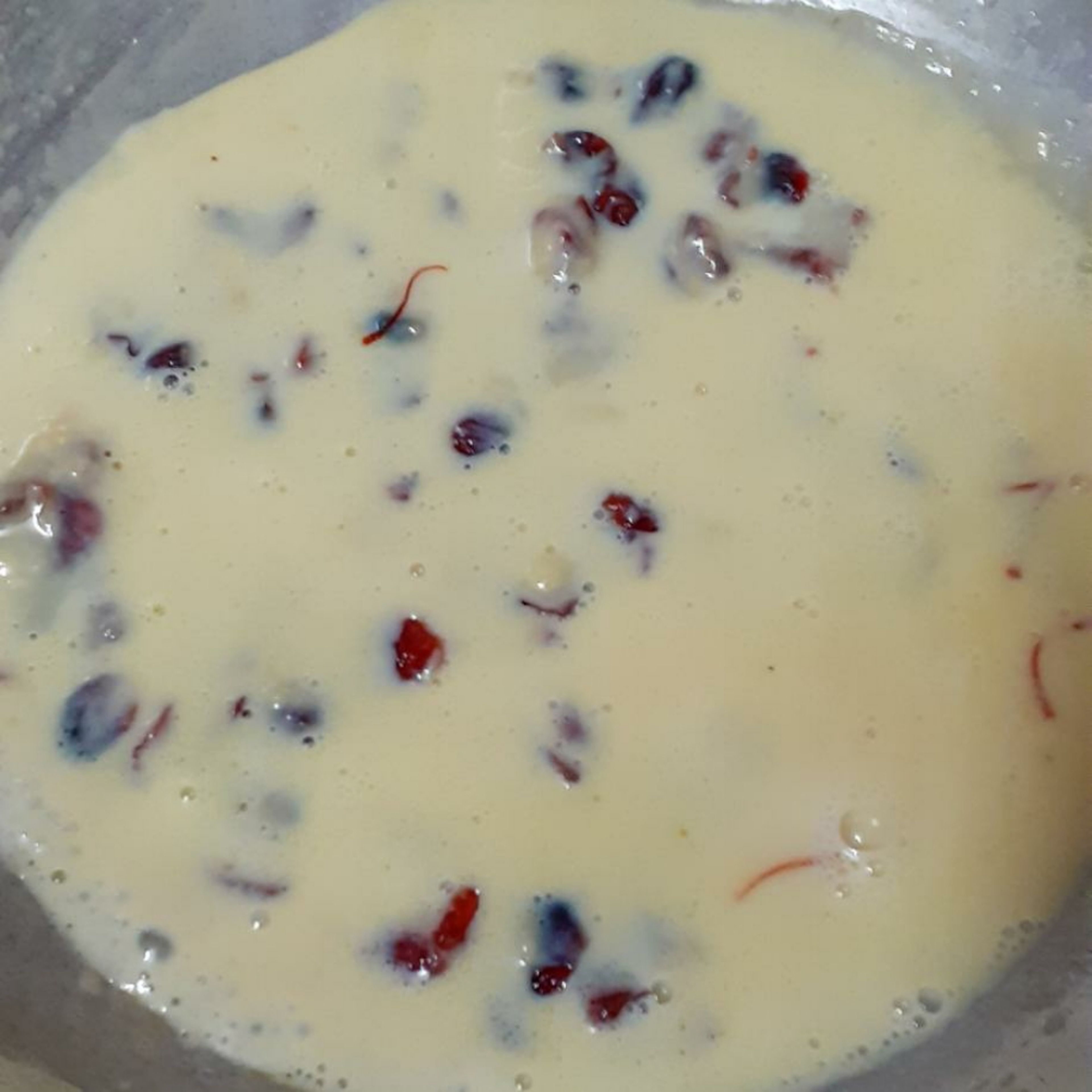 Add in the soaked saffron milk and chopped dried cranberries and cook on a low flame. (I prefer saffron, so soak it in the milk to be used for the recipe, before hand. Warm up the milk sligthly and a few saffron strands to the milk.) You can add in cardamom powder directly to the mixture instead of saffron.