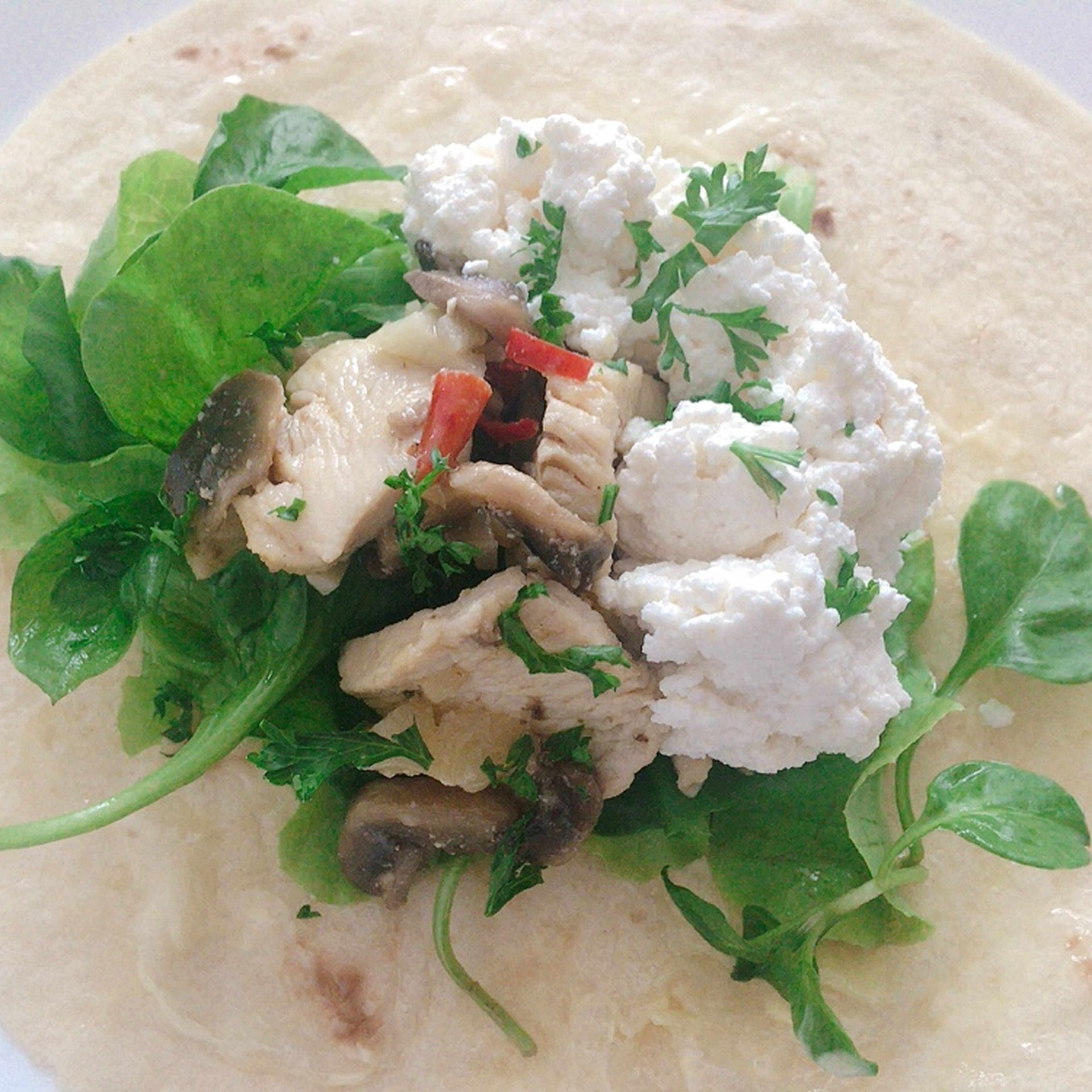 Warm up tortilla on a heated frying pan for a minute. Transfer tortilla to a plate and spread butter when it’s still hot so butter nicely melts. If you have canned liver pâté, you can also spread it over as it adds good saltiness and flavour to the dish. Place the filling, watercress, lettuce and cottage cheese on tortilla. Sprinkle parsley and add a few drops of balsamic vinegar. Lastly, wrap it and enjoy the dish.