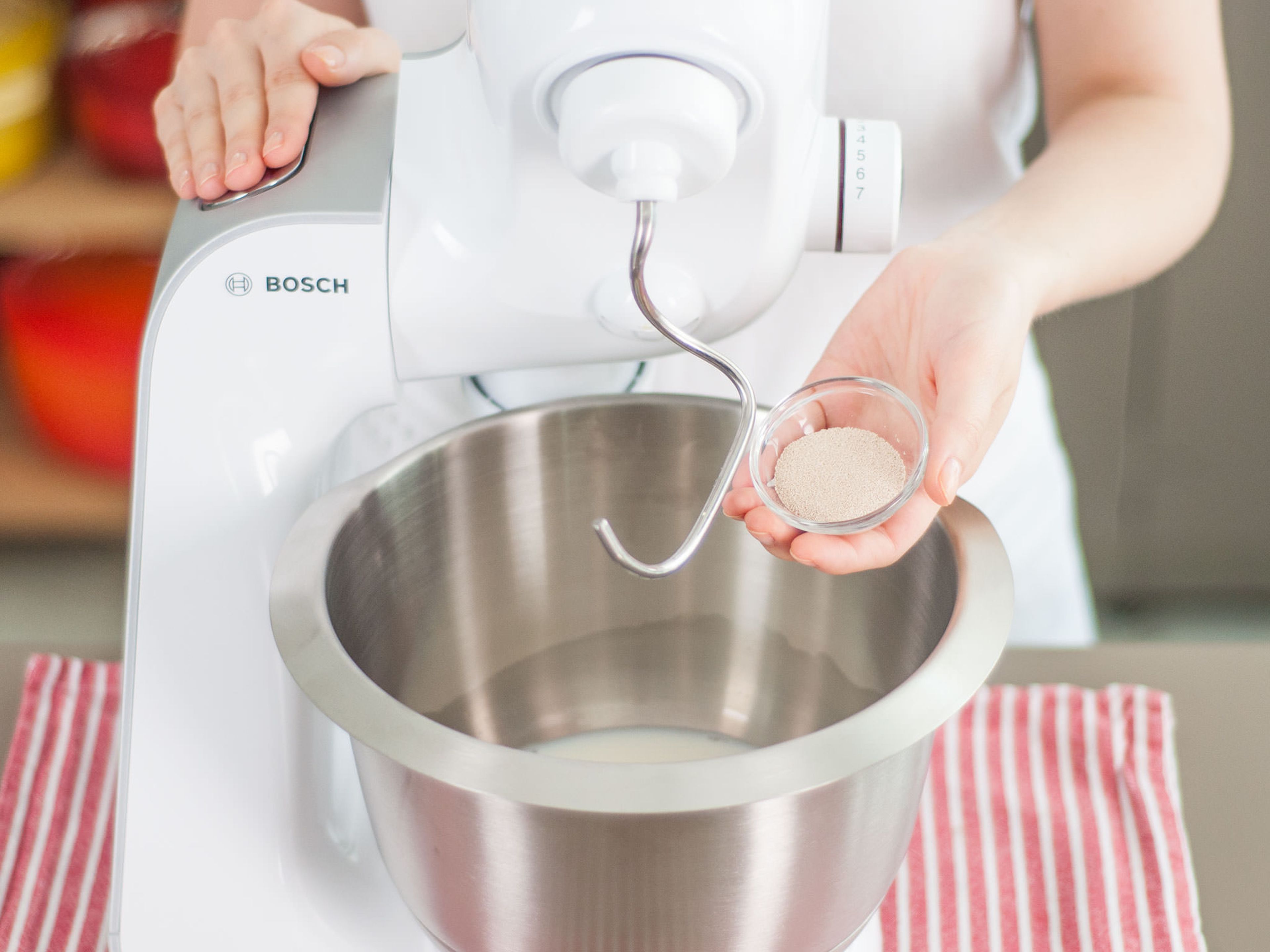 Combine yeast and milk in bowl of stand mixer, then cover and set aside until it turns foamy, approx. 10 min.