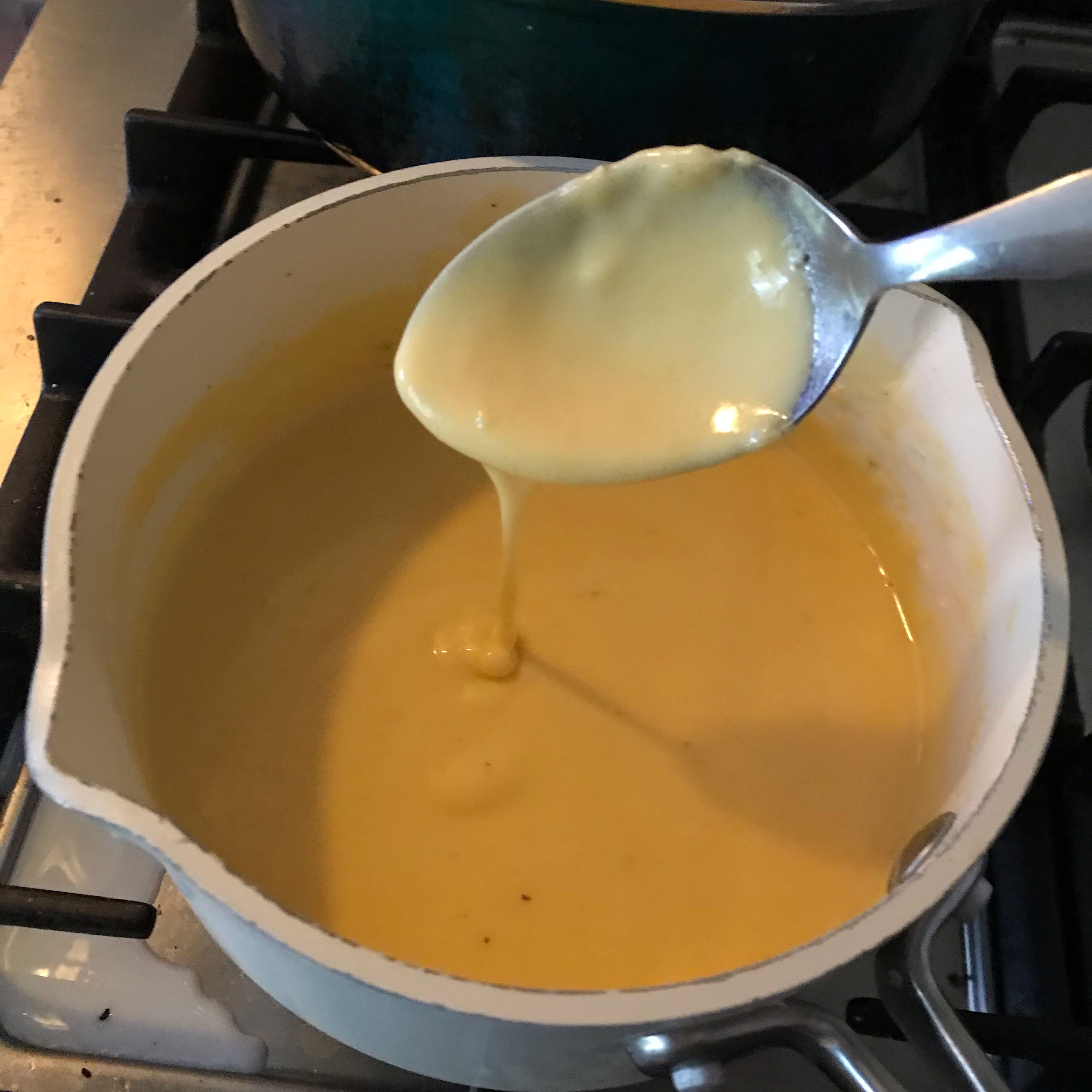 Add the slices of cheddar cheese and whisk until they’re melted in.