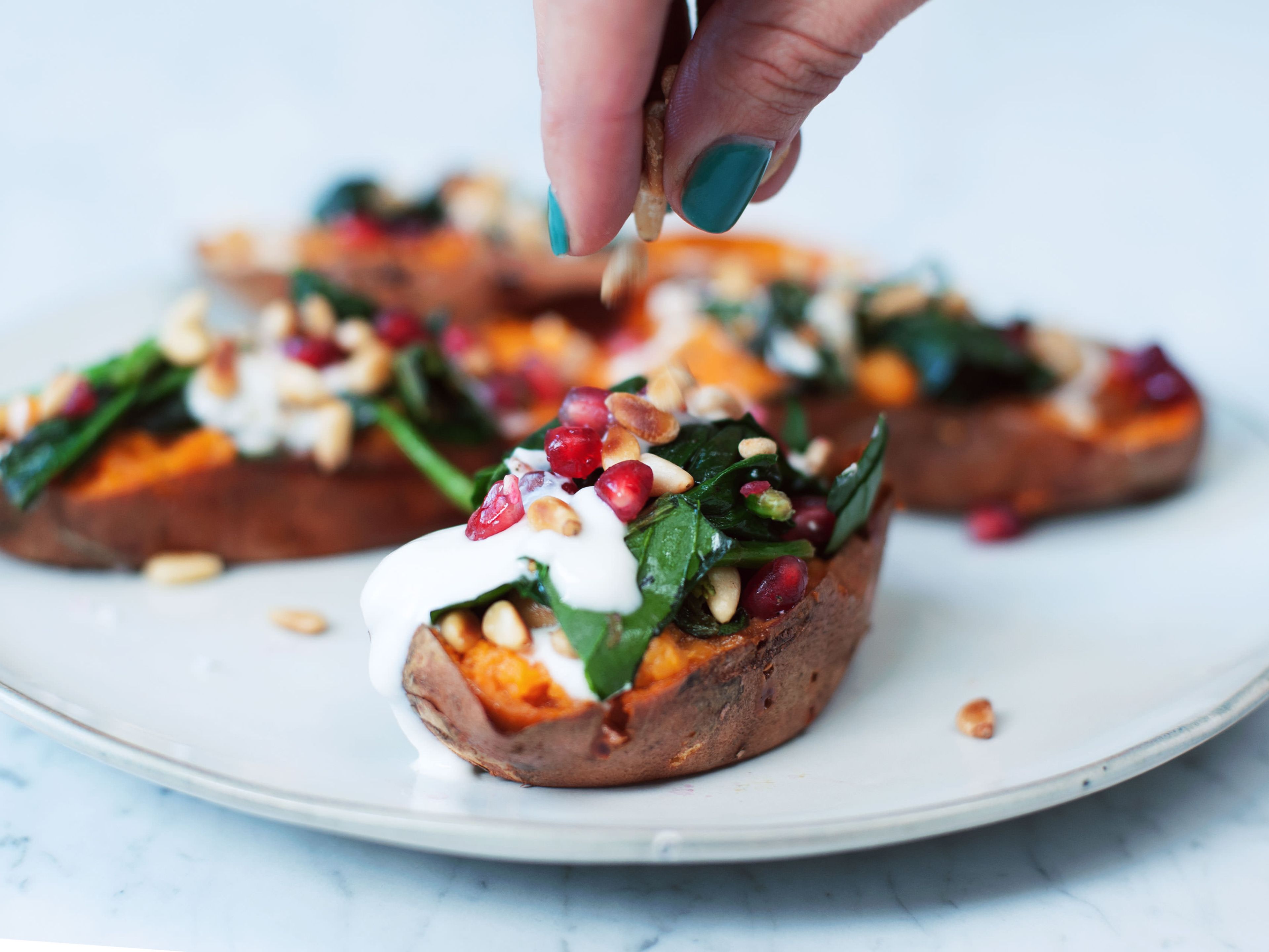 Baked sweet potatoes with spinach and pine nuts