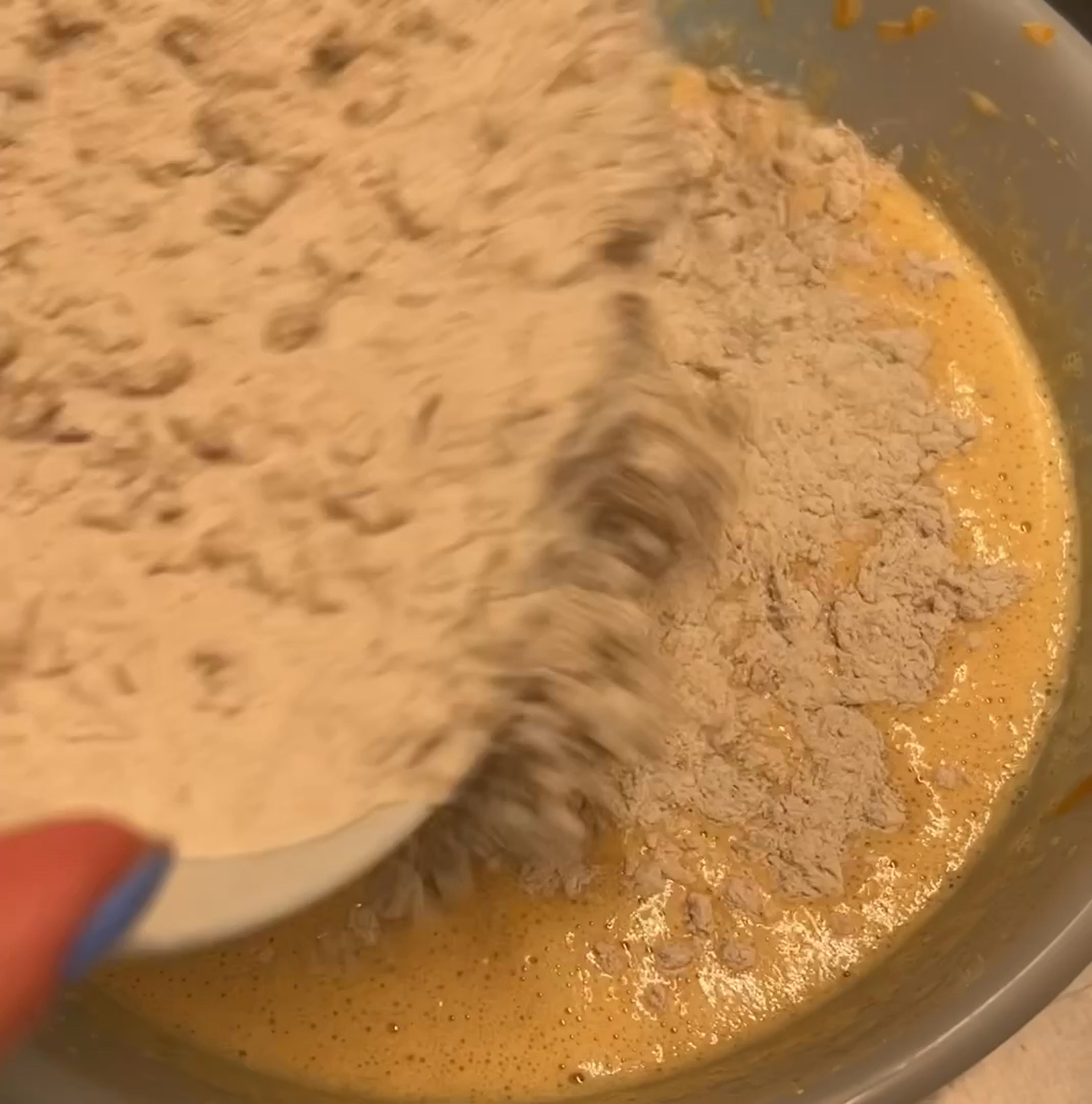 Add dry mixture (flour with walnuts) to a bowl with wet ingredients in two steps and carefully whisk all together with a hand mixer. Don't over mix the butter because in the end the dough can become tender.
