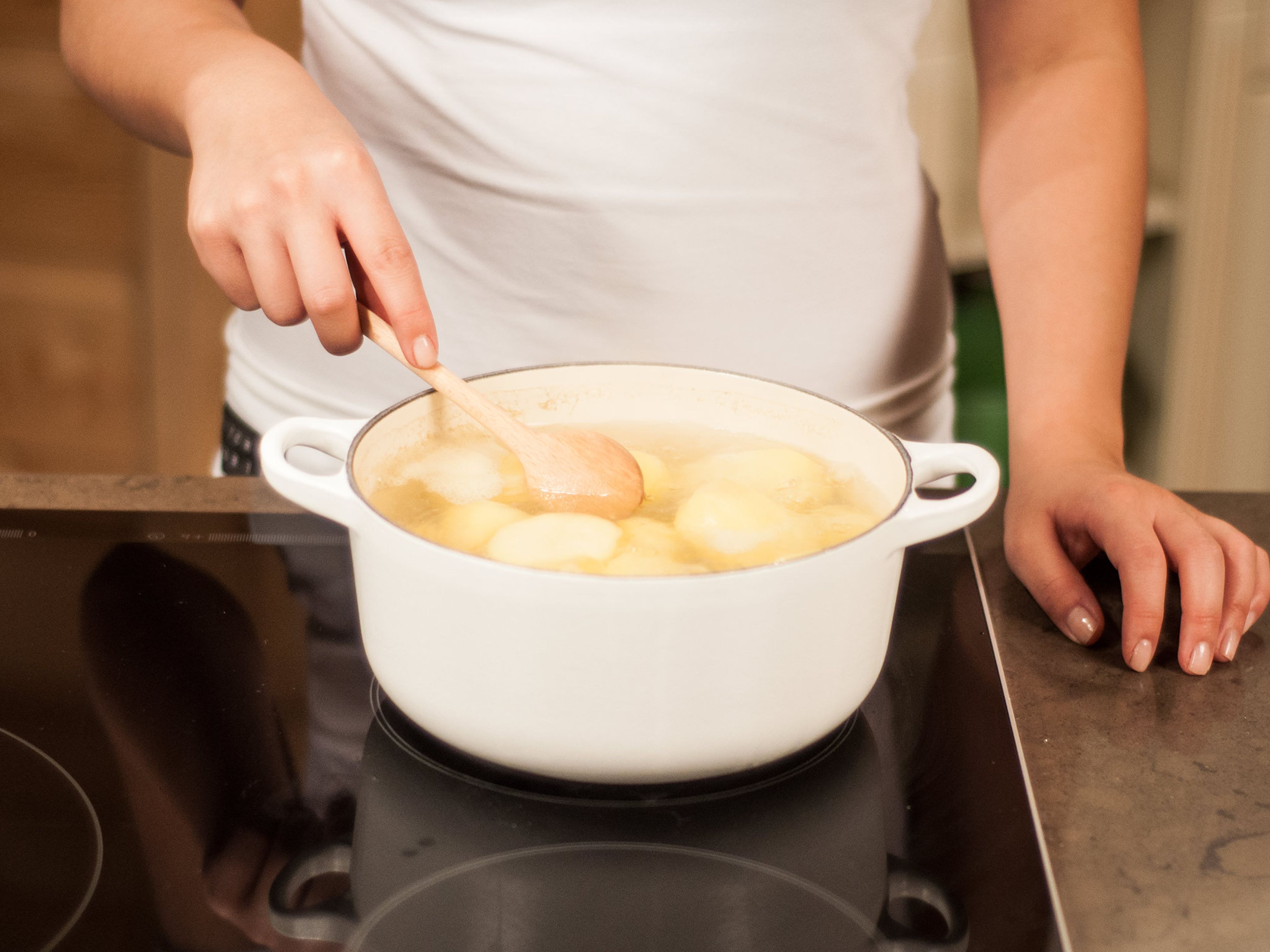 Transfer potatoes to a large saucepan. Cover with water, add some salt, and bring to a boil. Then reduce to a simmer and cook for approx. 20 – 30 min. until tender. Drain and set aside to cool for approx. 15 min.