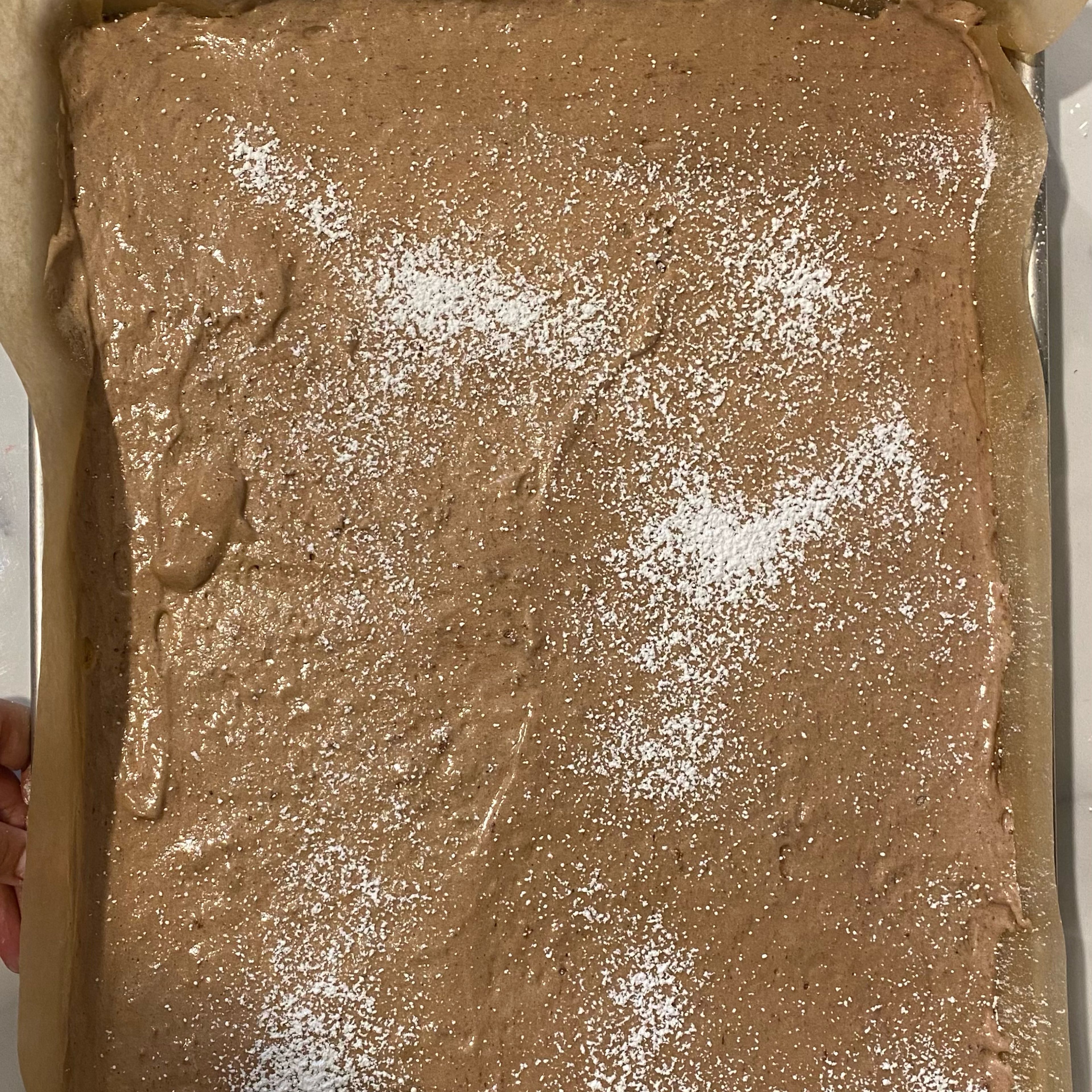 Evenly spread the batter onto a prepared sheet pan. Avoid overworking the batter and deflating it. Dust the batter with a little bit of confectioner's sugar (optional). Bake the cake for about 15-18 minutes, or until the edges are springy to the touch, and a skewer comes out clean. 