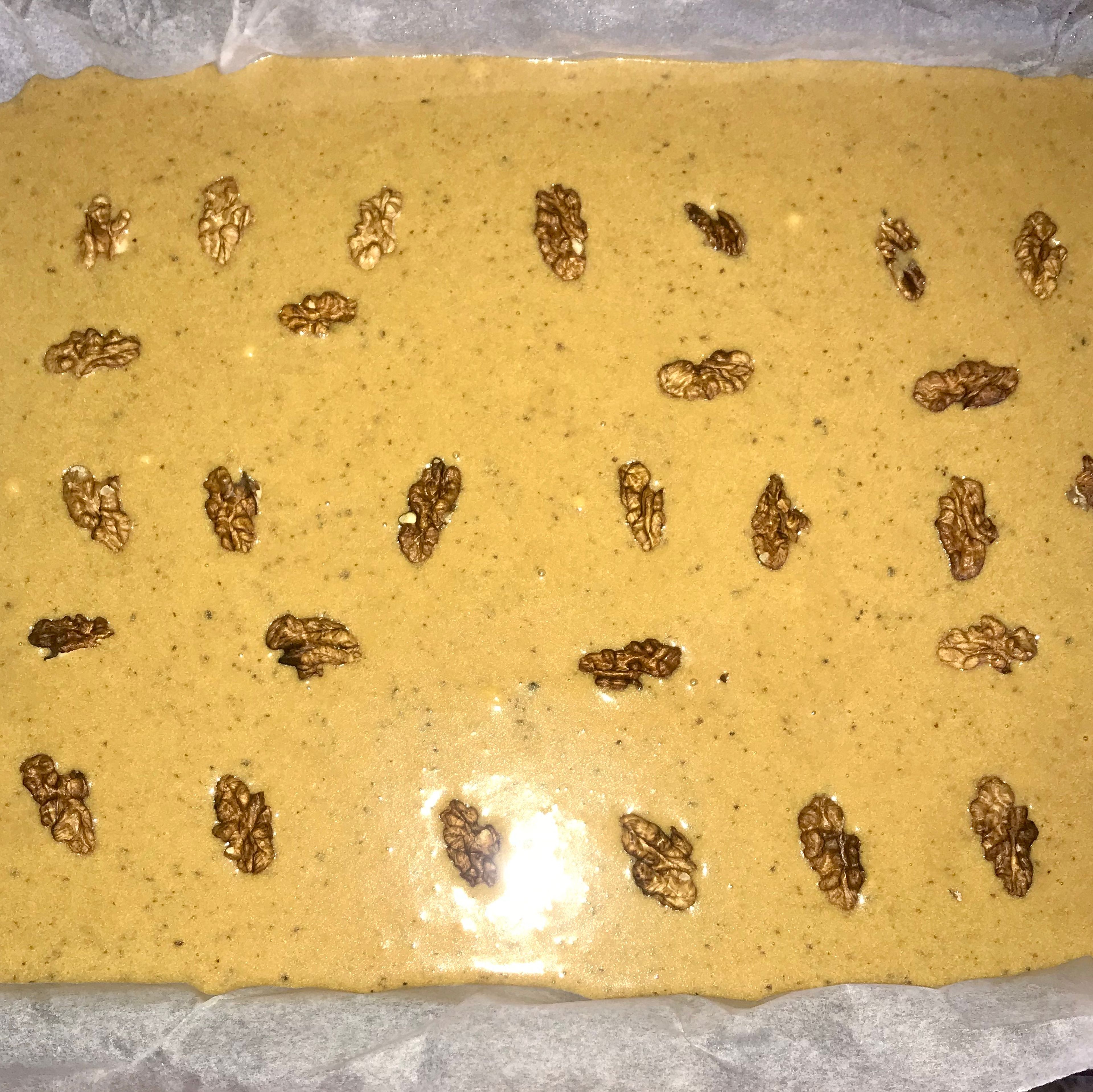 Spoon the mix into the tray and top it with the walnut halves. Then bake for 18-20 mins until light golden and springy. Cool for a few mins in the tin, then lift the cake out and cool on a rack.