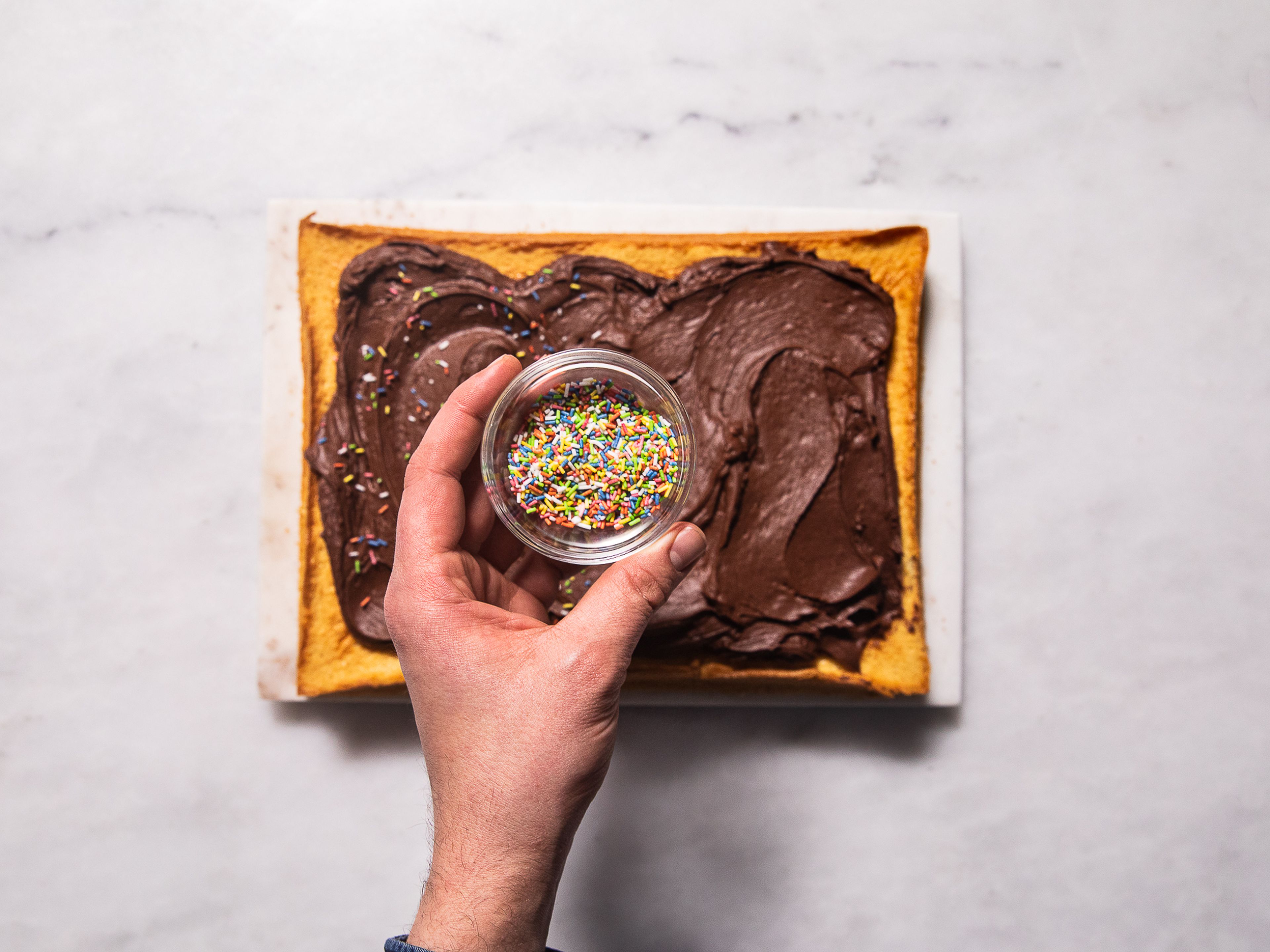 Spread the chocolate frosting over the cooled cake and decorate with sprinkles, if desired. Slice and enjoy!