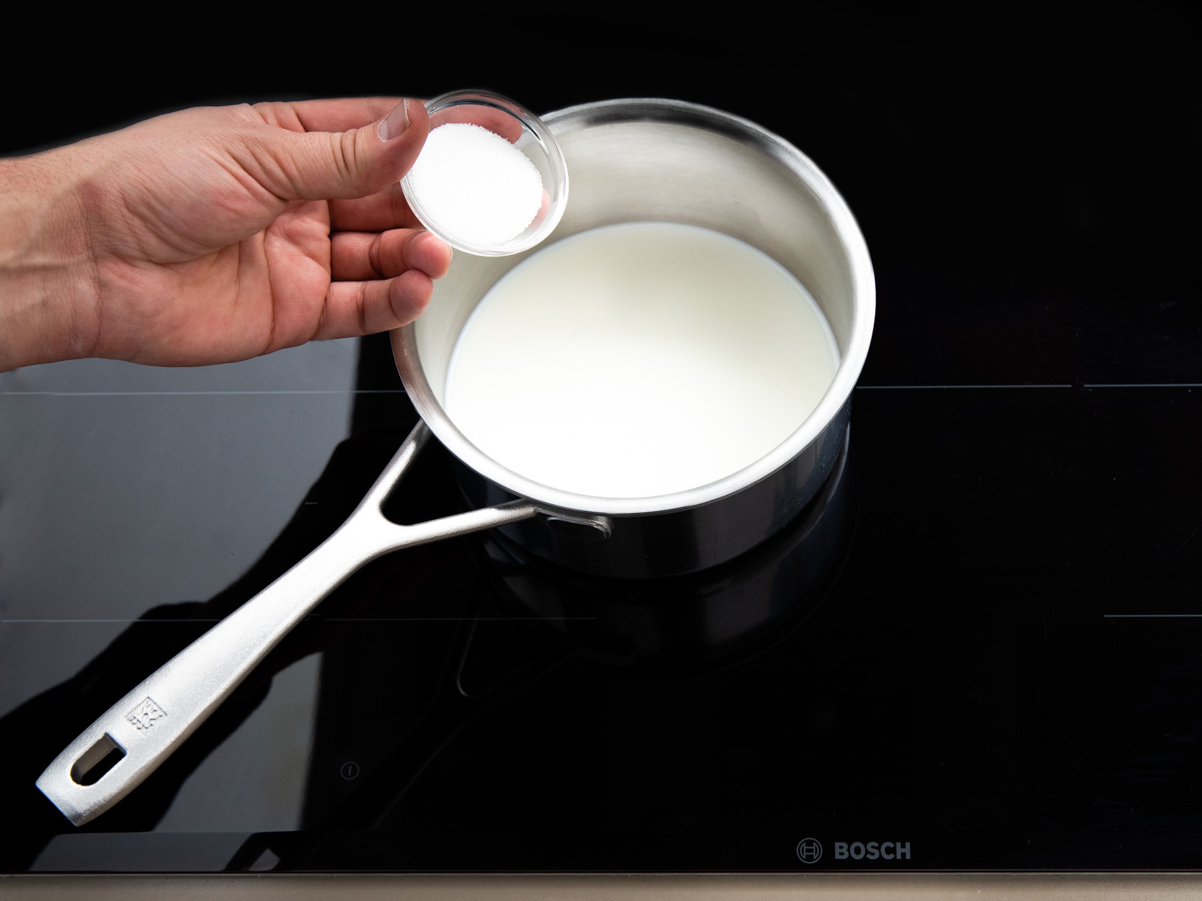Gently heat milk in a pot over medium-low heat until just lukewarm. Add fresh yeast and some of the sugar and whisk for approx. 2 - 3 min., until the yeast is completely dissolved.