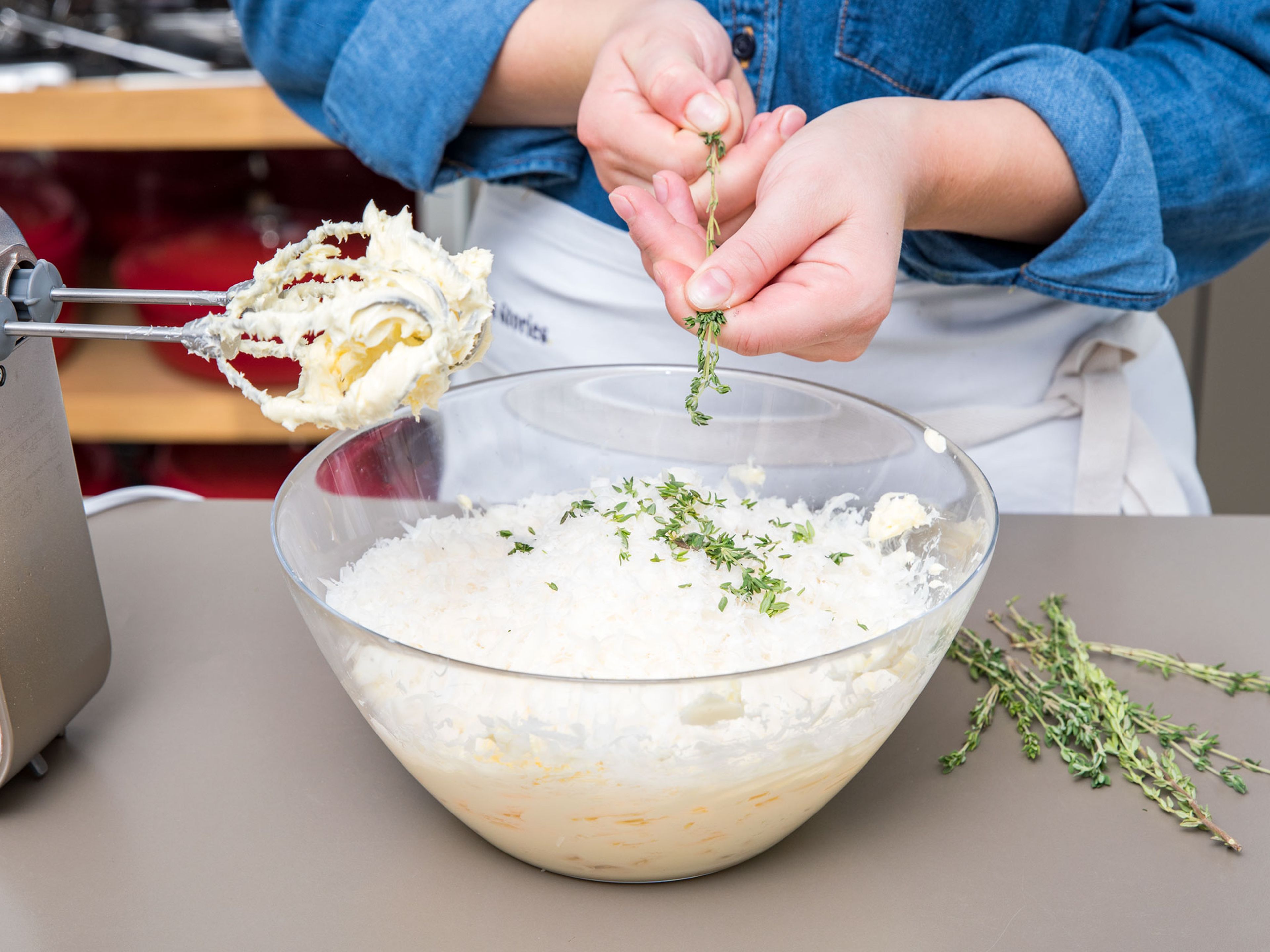 Preheat oven to 180°C/355°F. Pluck fresh thyme leaves from sprigs and set aside. Add soft butter to a bowl and beat with a hand mixer until fluffy. Add grated Parmesan cheese, salt, pepper, and thyme leaves and keep beating until combined. Finally, add flour and starch and stir to combine.