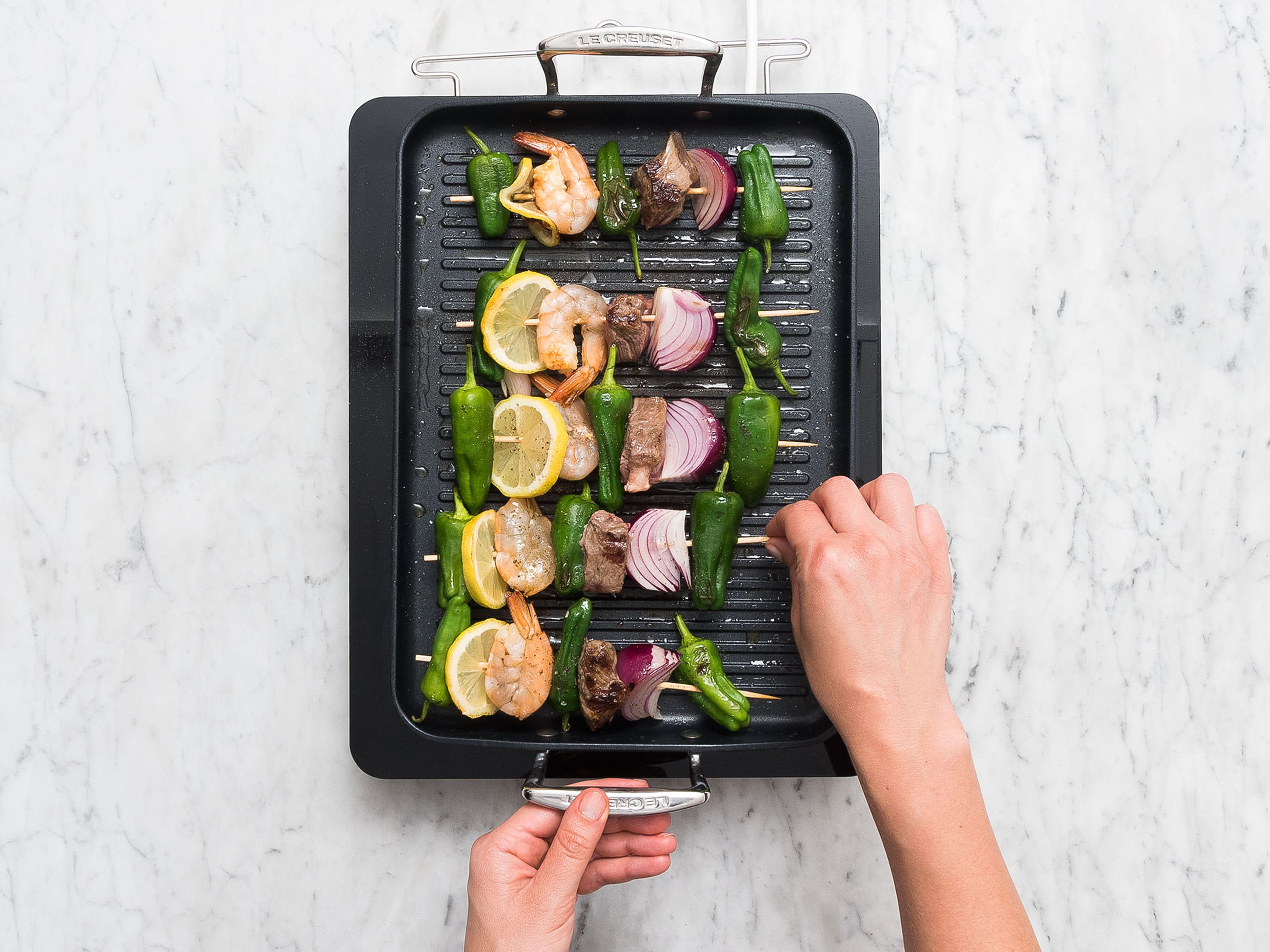 Heat olive oil in a large pan over medium-high heat, add skewers, and sear for approx. 2 – 3 min. Reduce heat and fry for approx. 2 - 3 min. more. Season with salt and pepper to taste. Serve with homemade dip. Enjoy!