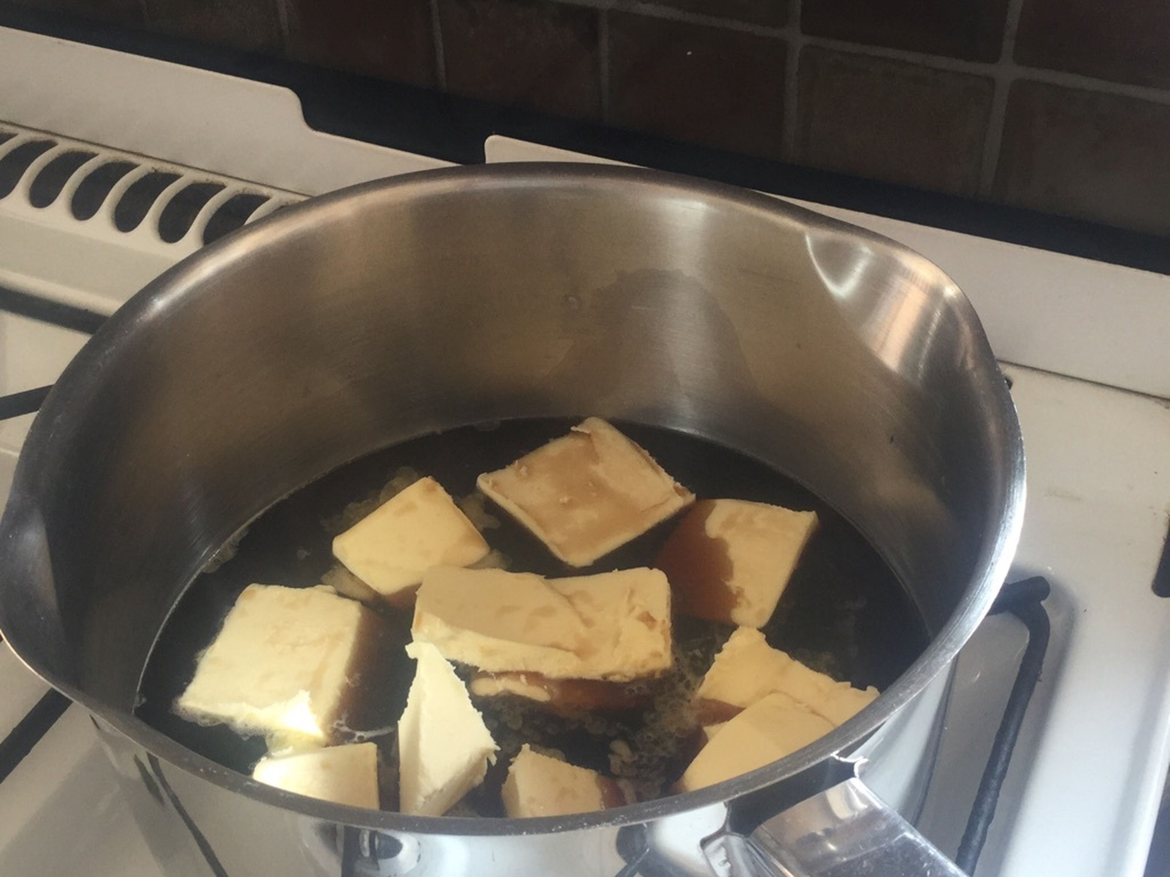 Pre-heat the oven to 160°C/320°F and grease the baking pan. In a saucepan, heat the Guinness and chopped butter until the butter melts.