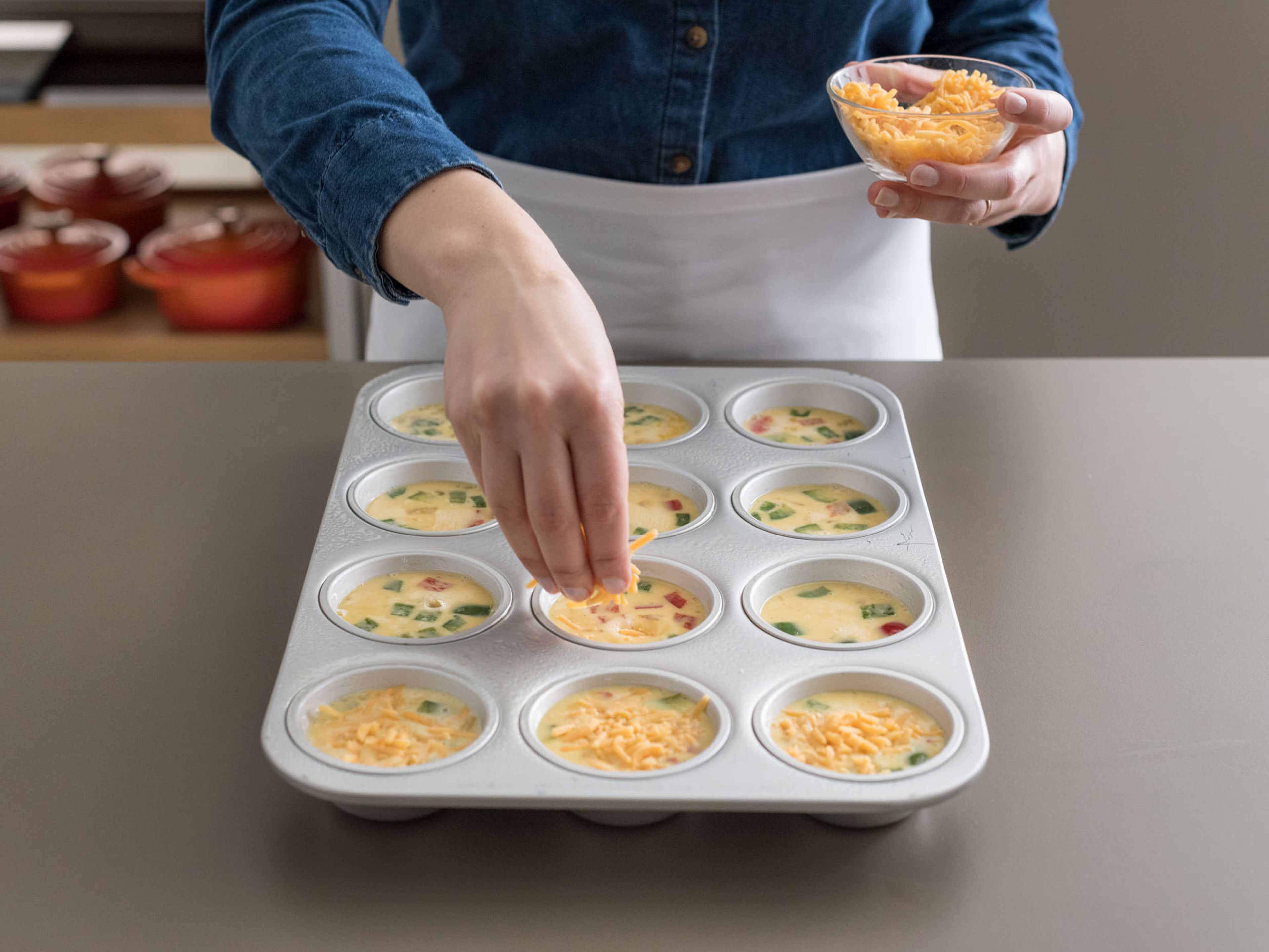 Pour egg mixture into cups, filling each three-quarters of the way full. Sprinkle with cheese.